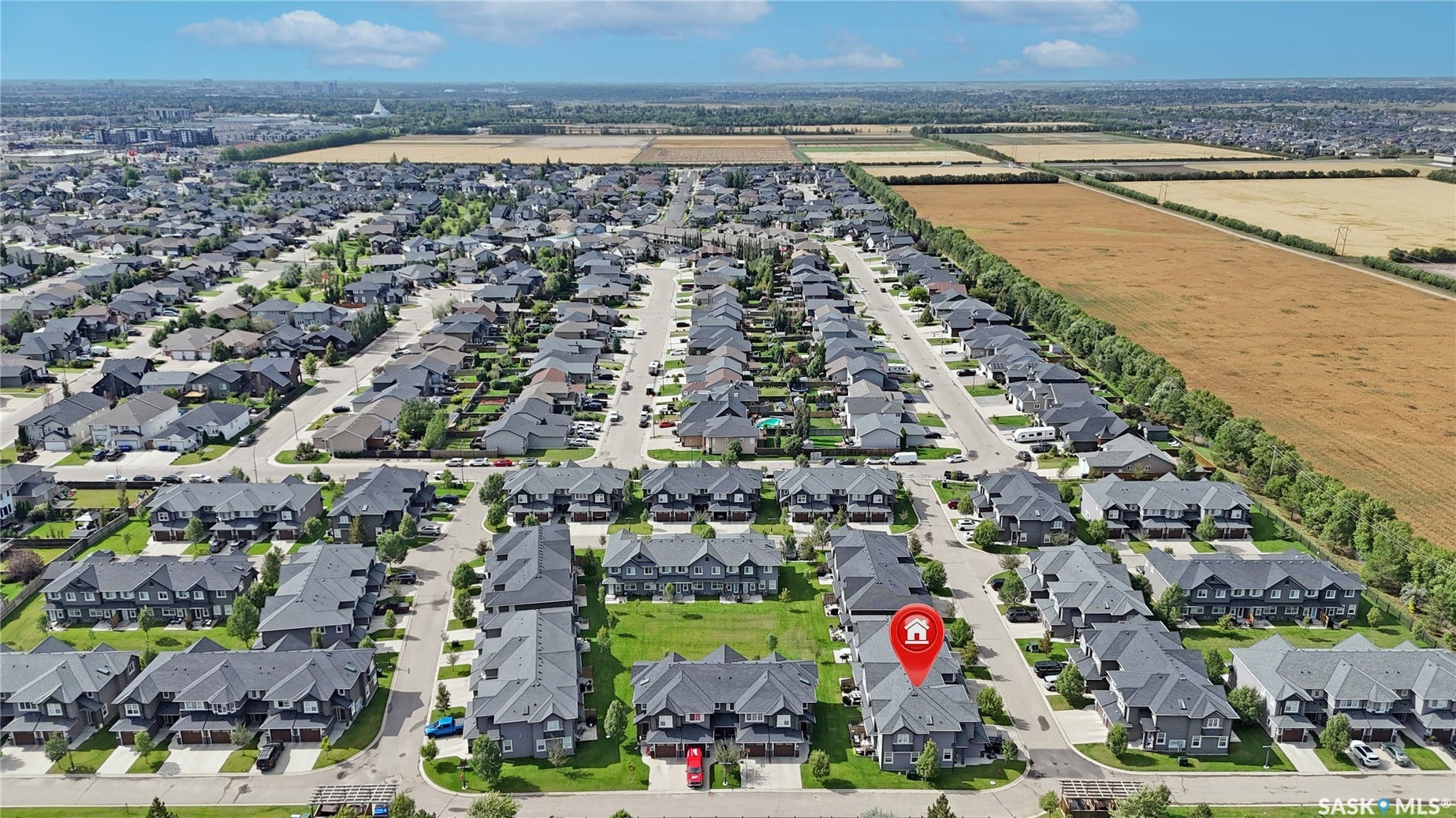 Residential area featuring detached and attached properties with asphalt shingle roofs and green landscaping