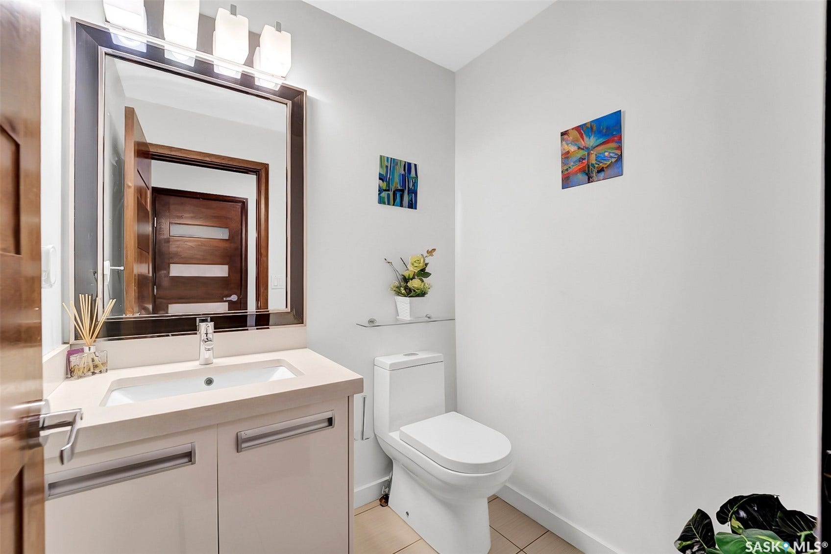 White vanity with an integrated rectangular sink, chrome faucet, and contemporary hardware