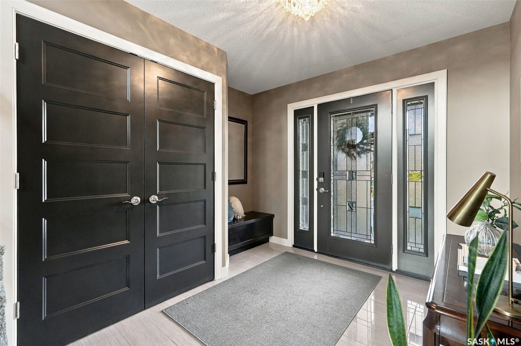 4414 Sandpiper Crescent E, Regina SK S4V 1N3 Entryway featuring a decorative front door with transom windows, double panel doors, and tile flooring