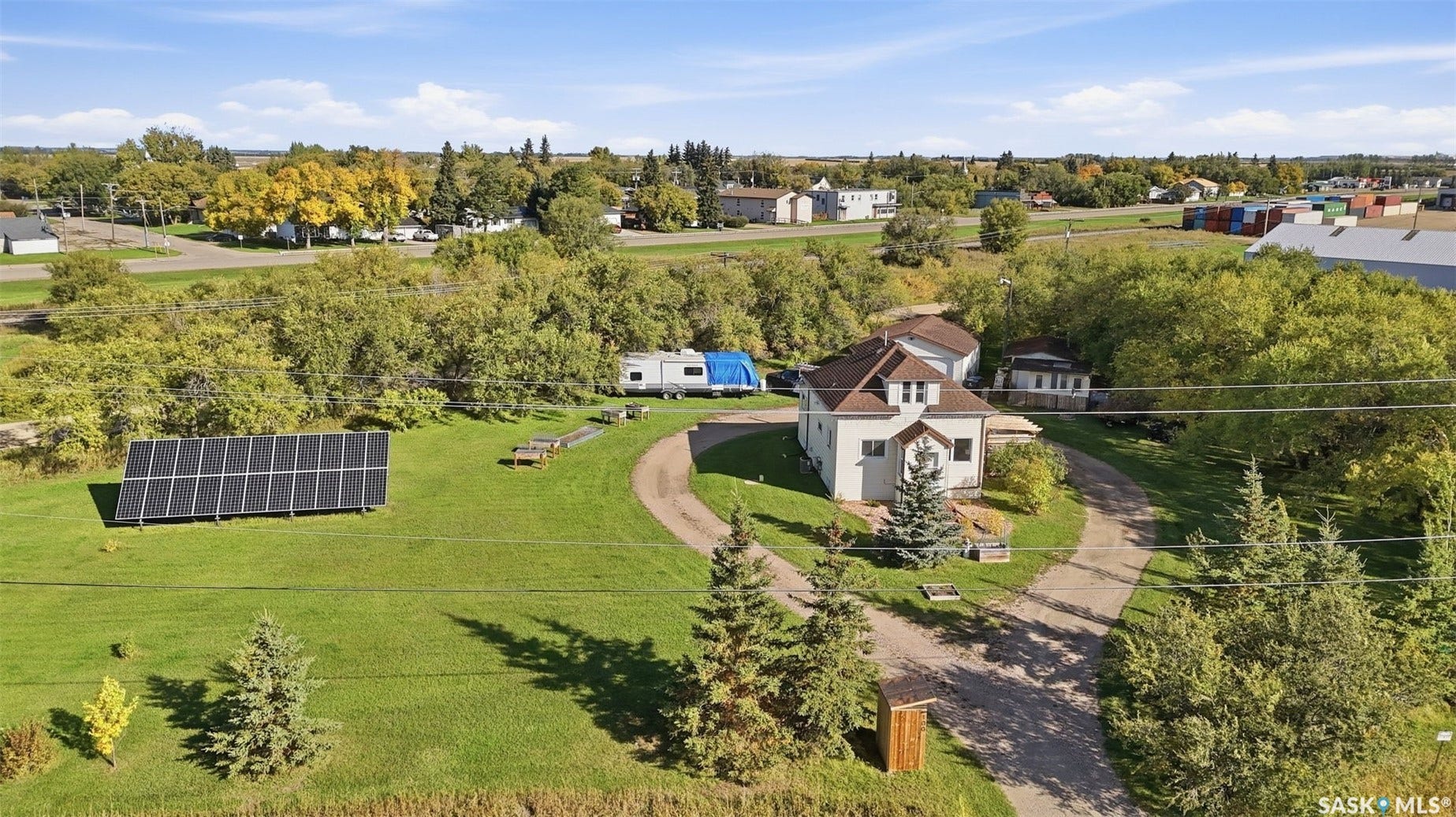 Gable-roof property featuring a detached outbuilding and solar panel array