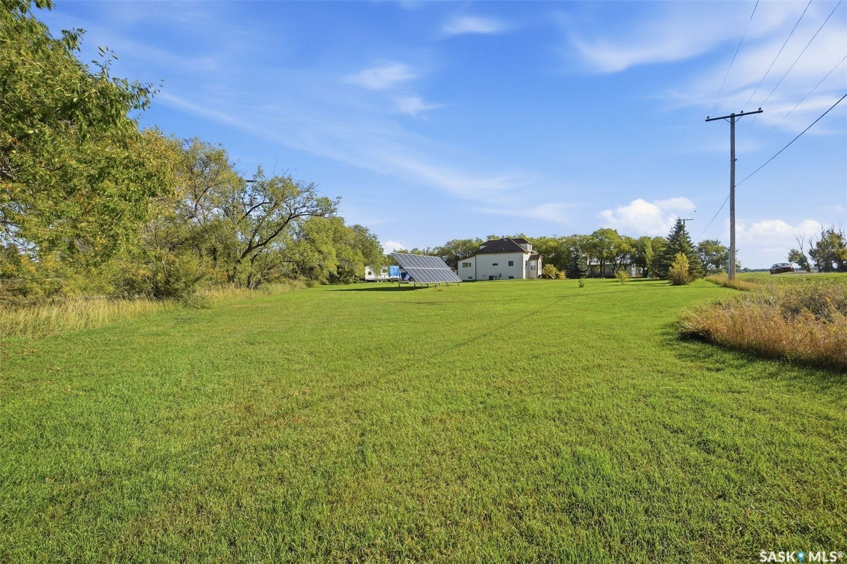 Expansive green lawn with a solar panel array