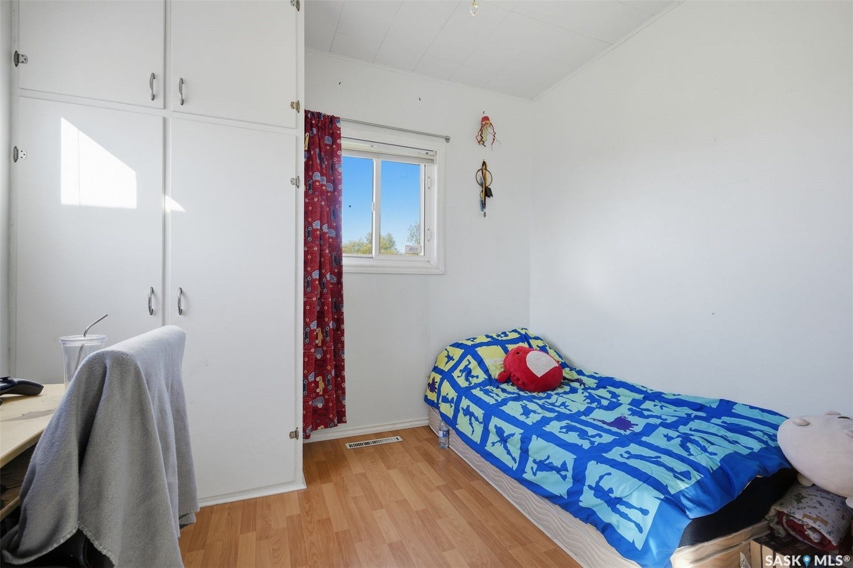 Wood-finish flooring with white walls and a white ceiling