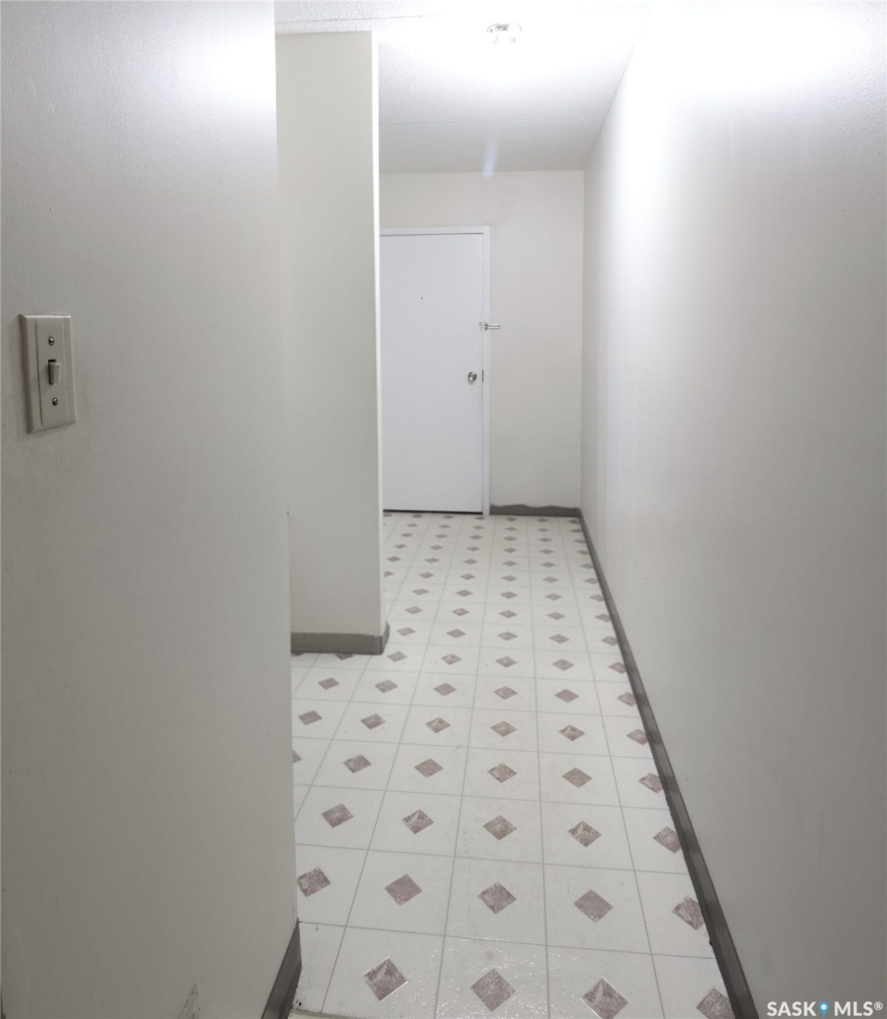Patterned floor tiles extending through the space