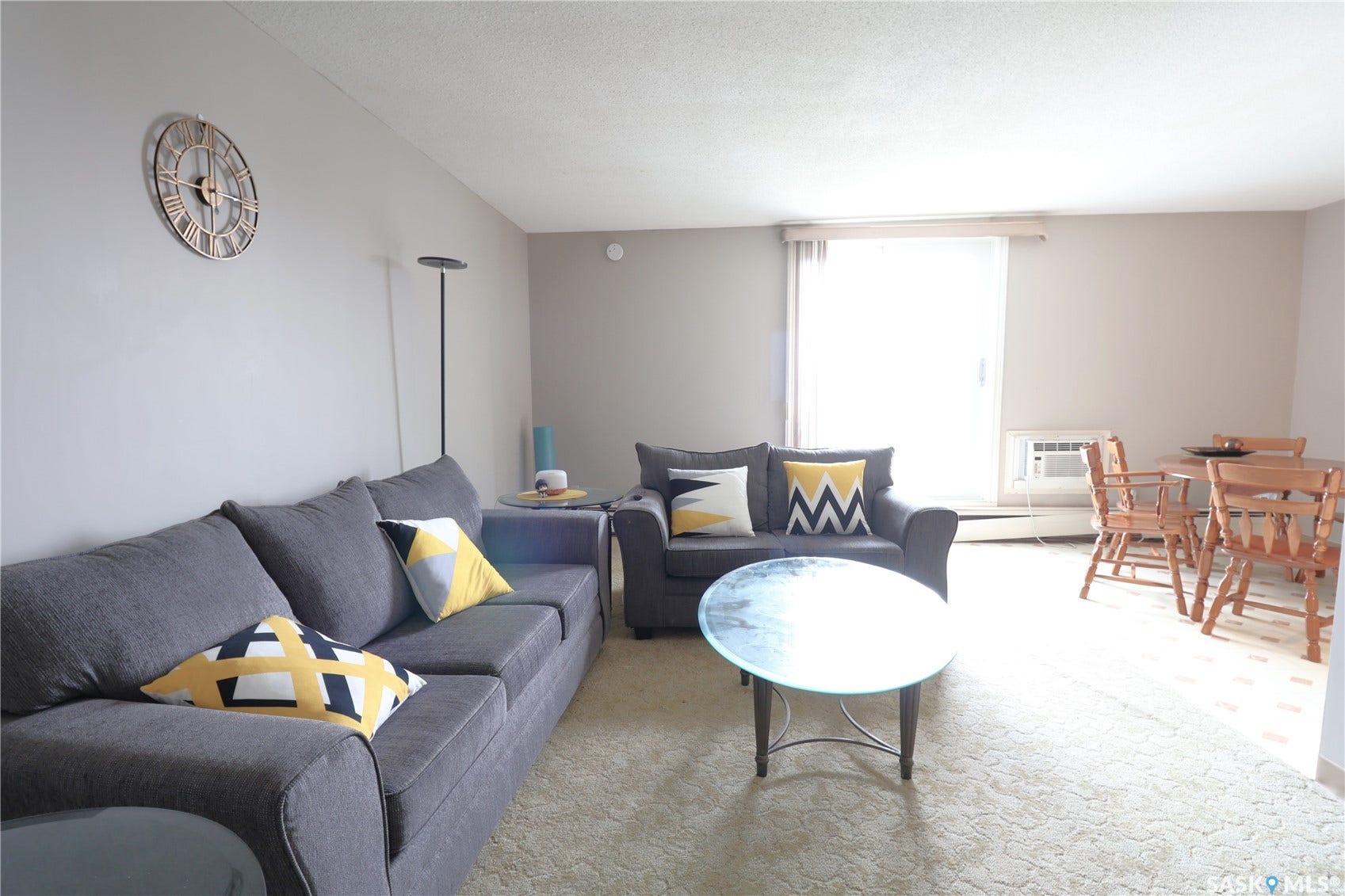 Wall-mounted air conditioning unit, light-colored walls, and a sliding glass door
