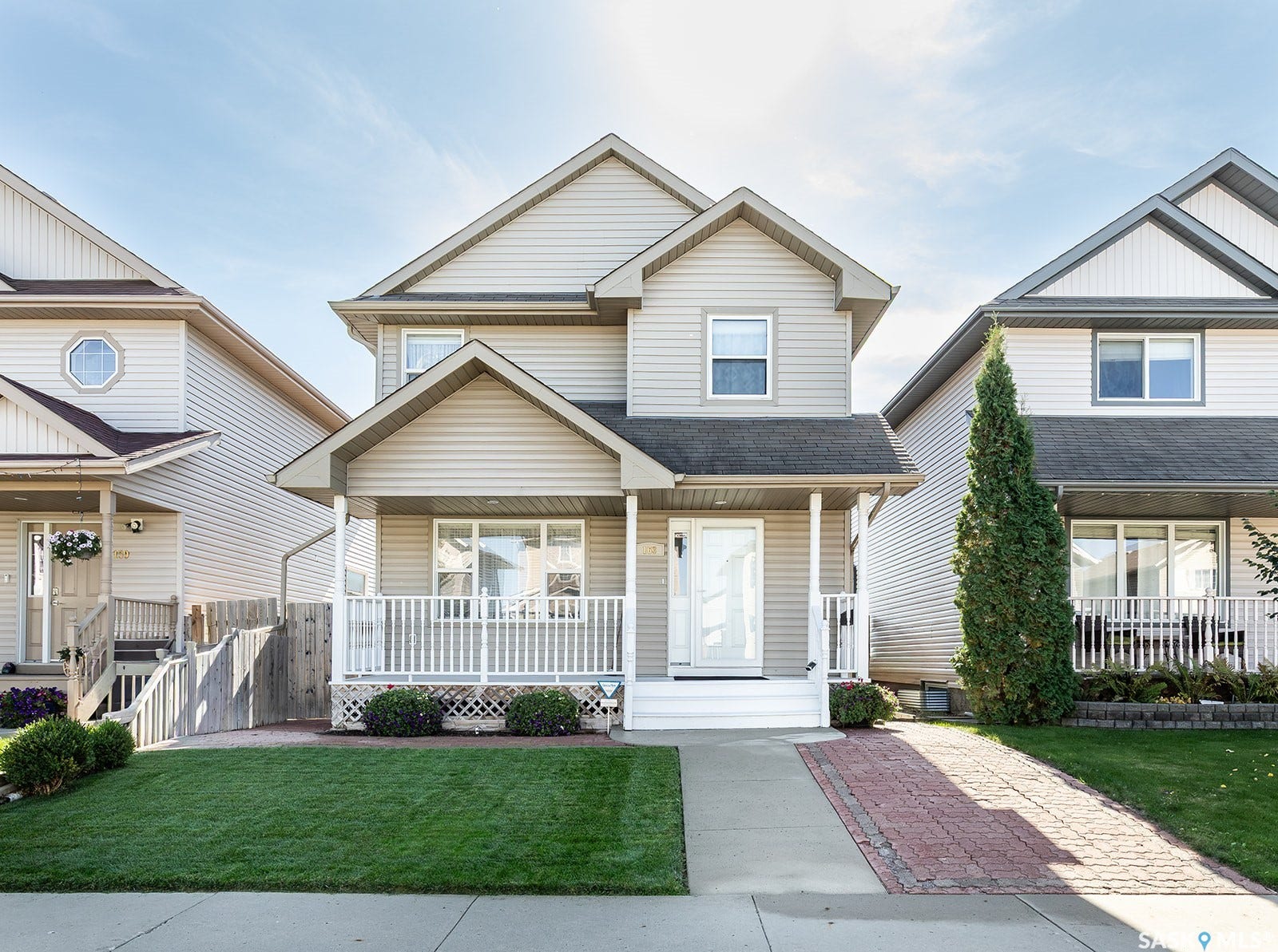 Two-story home with a gabled roof and light-colored siding