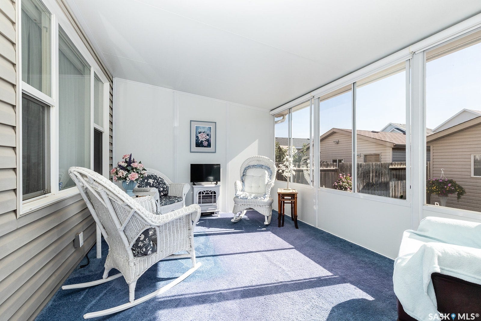 Enclosed sun room with multiple large windows