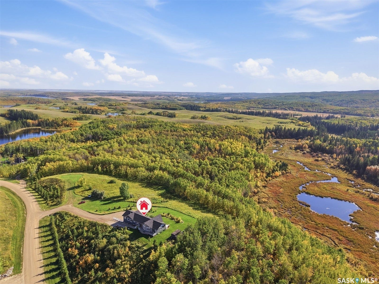 Expansive natural landscape with varied topography, including dense tree coverage and water features