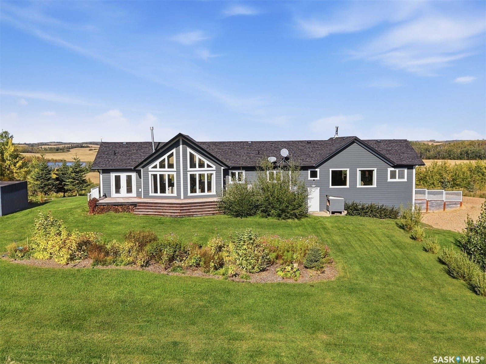 Gray-sided residence with a dark shingle roof