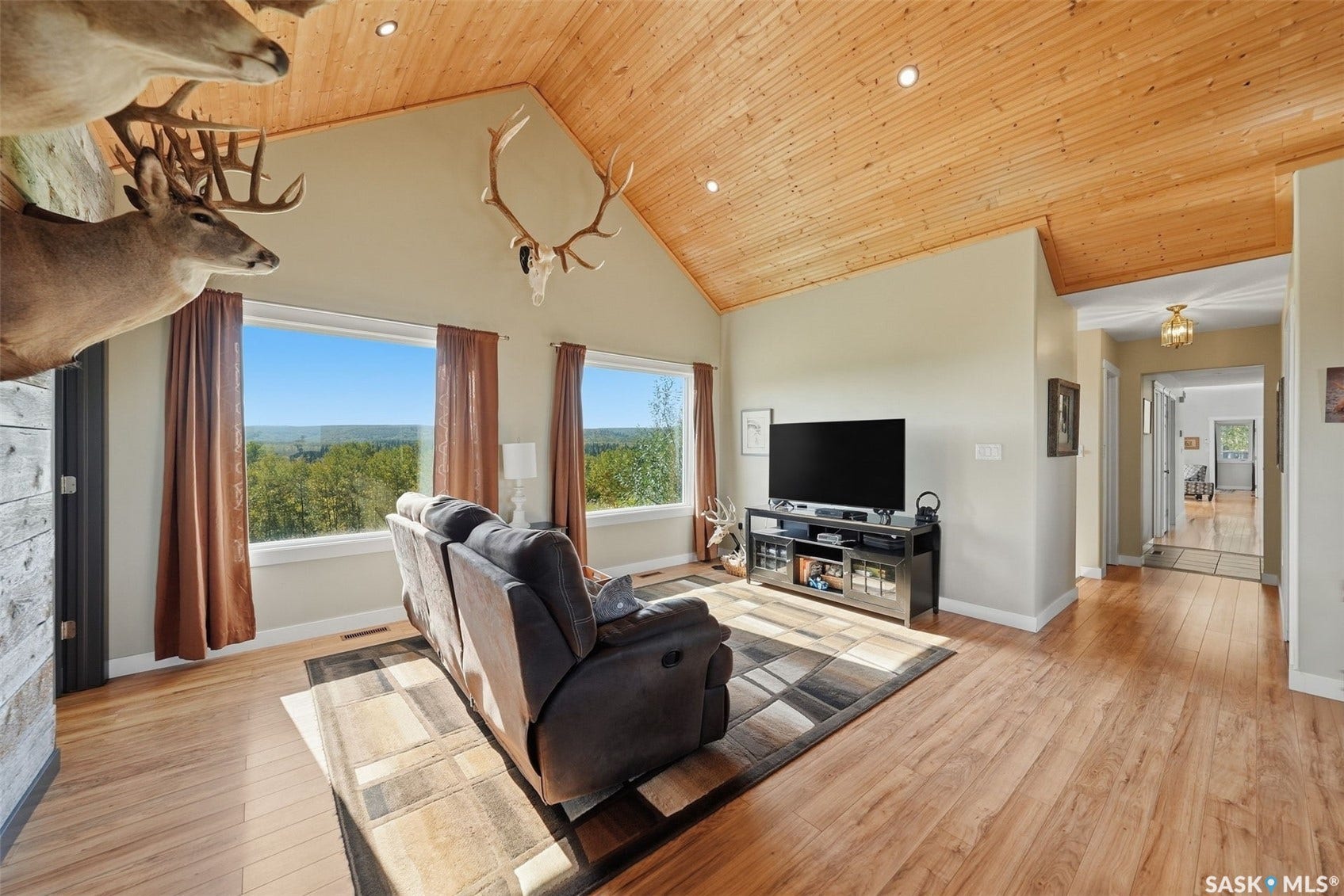 Vaulted wood-paneled ceiling, recessed lighting, wood-finish flooring, multiple windows, and light-toned wall finishes