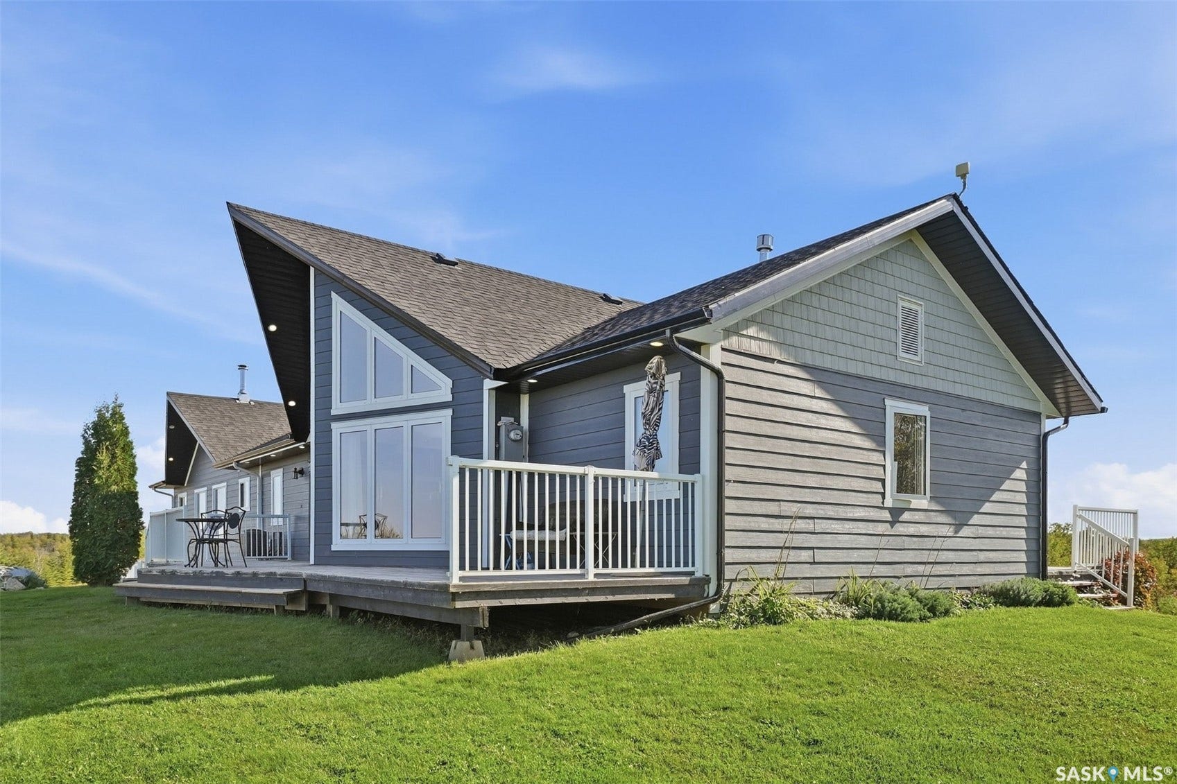 Contemporary exterior with dark gray siding and a steep-pitched roofline