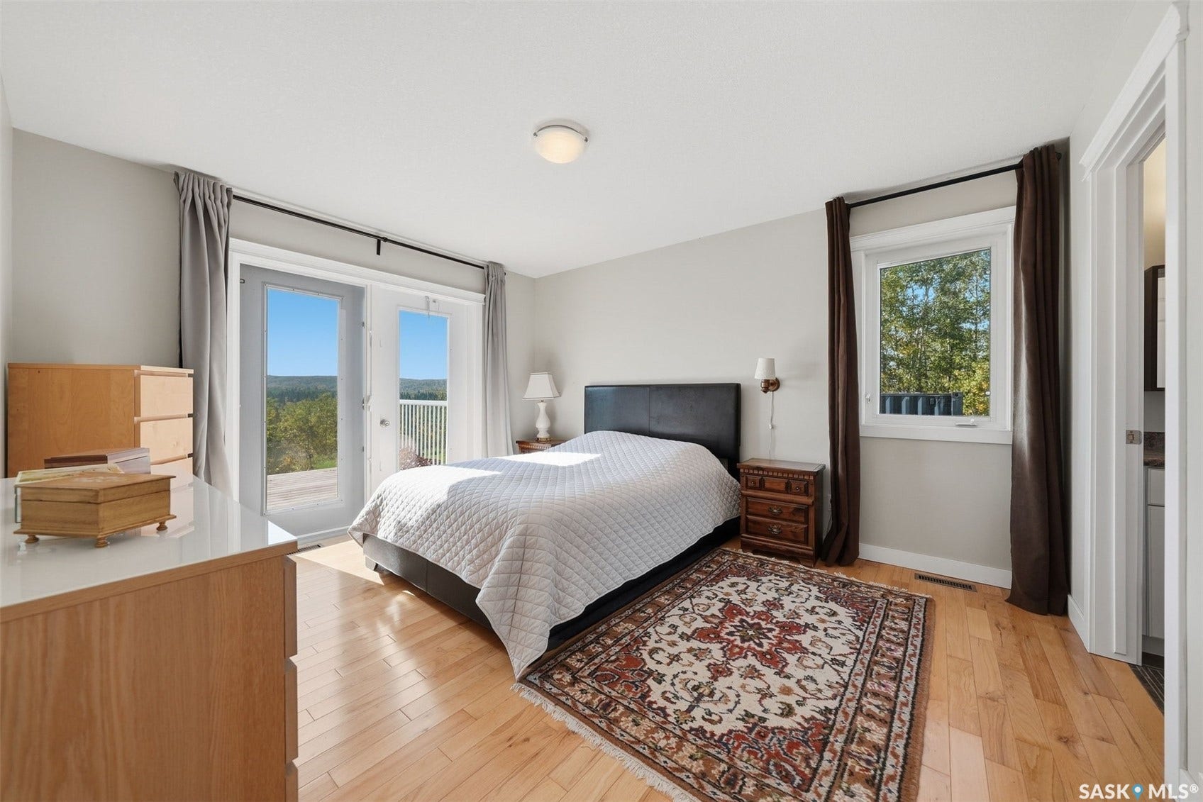 Hardwood-finish flooring, recessed lighting, and a window providing natural illumination