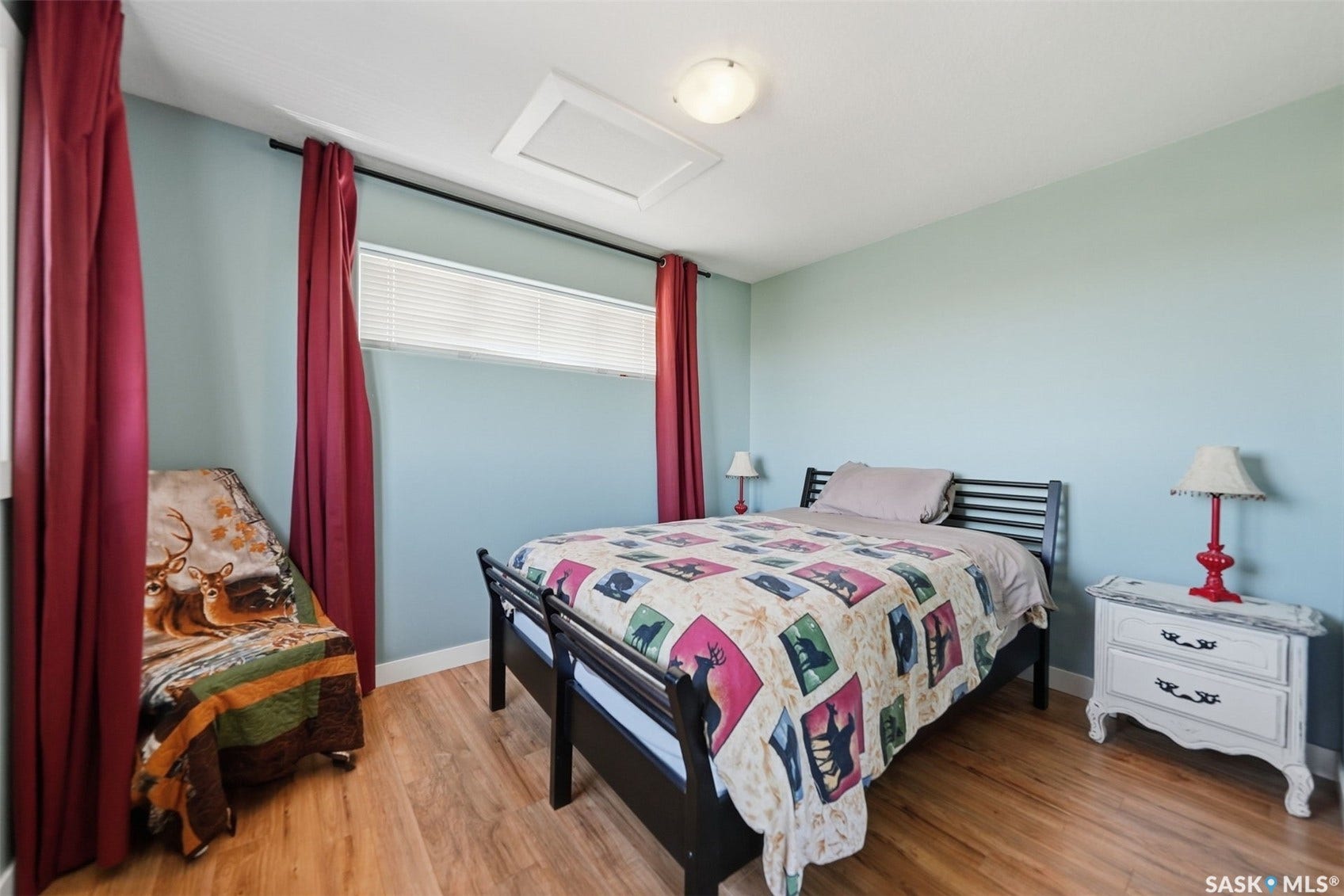 Wood-finish flooring, ceiling-mounted light fixture, and window with blinds