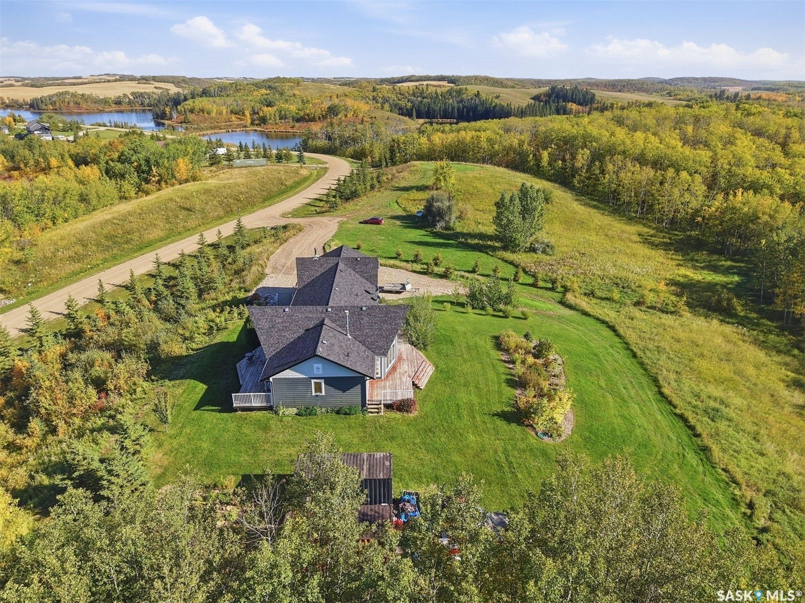 Expansive property with a multi-level home featuring dark shingle roofing