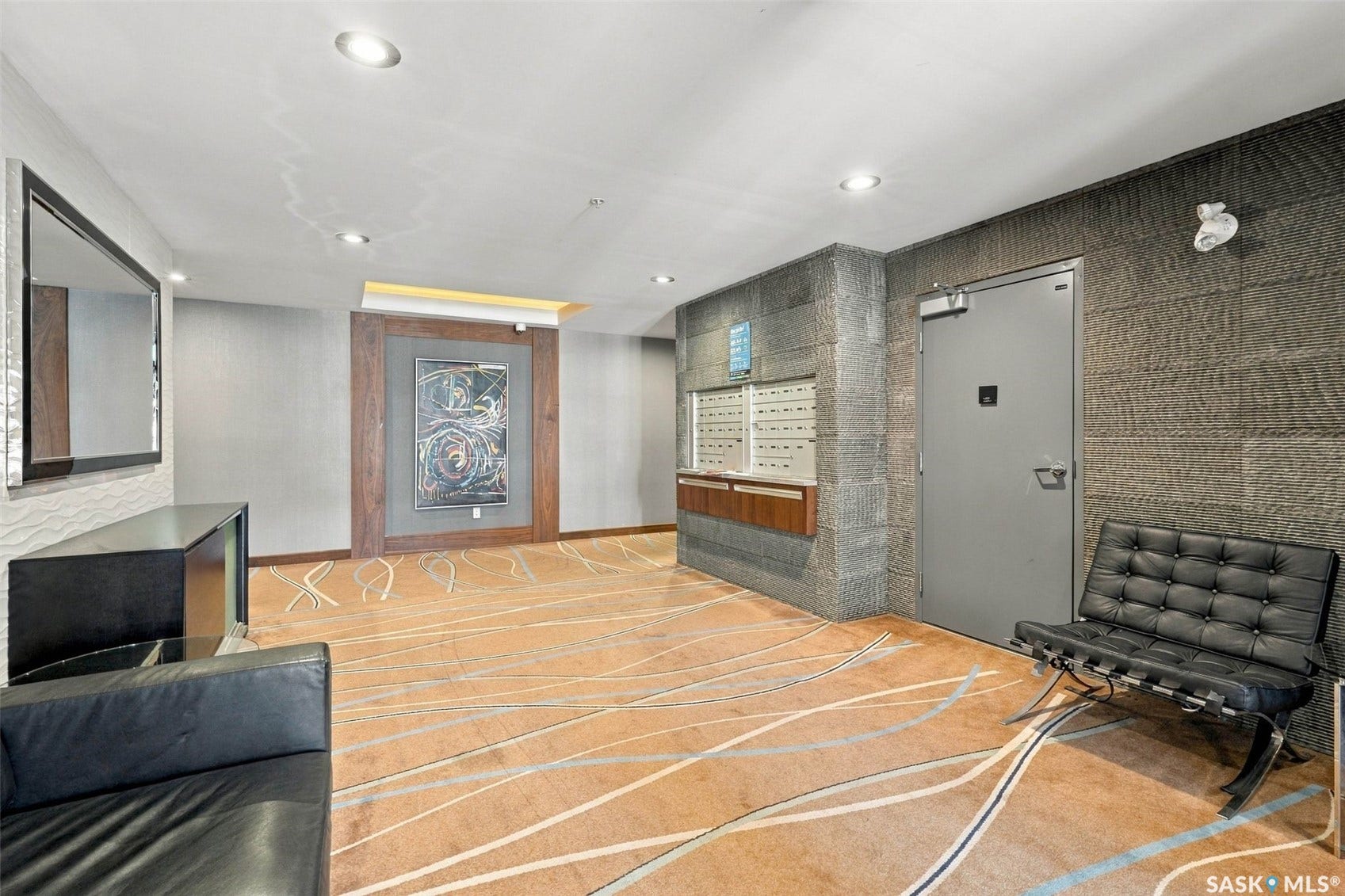 Recessed lighting illuminates the space, featuring a durable commercial-grade door and built-in mailboxes