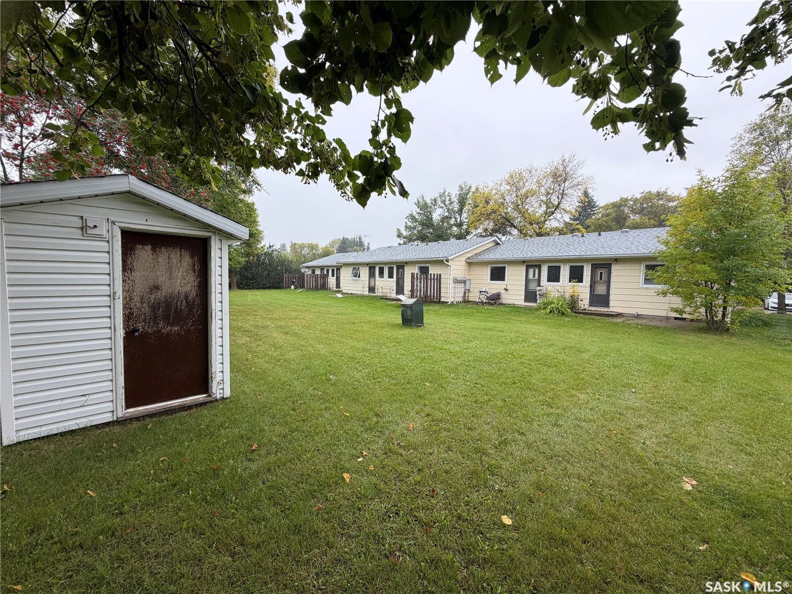 301 2nd Street, #1-10, Kennedy SK S0G 2R0 Expansive green space featuring a detached storage shed with vinyl siding