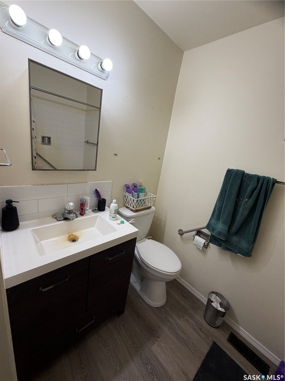 301 2nd Street, #1-10, Kennedy SK S0G 2R0 Vanity with integrated sink, white countertop, dark wood-finish cabinetry, and contemporary pulls