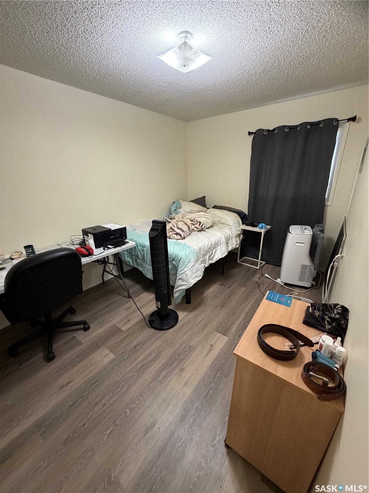 301 2nd Street, #1-10, Kennedy SK S0G 2R0 Wood-finish flooring, neutral wall tones, and overhead lighting