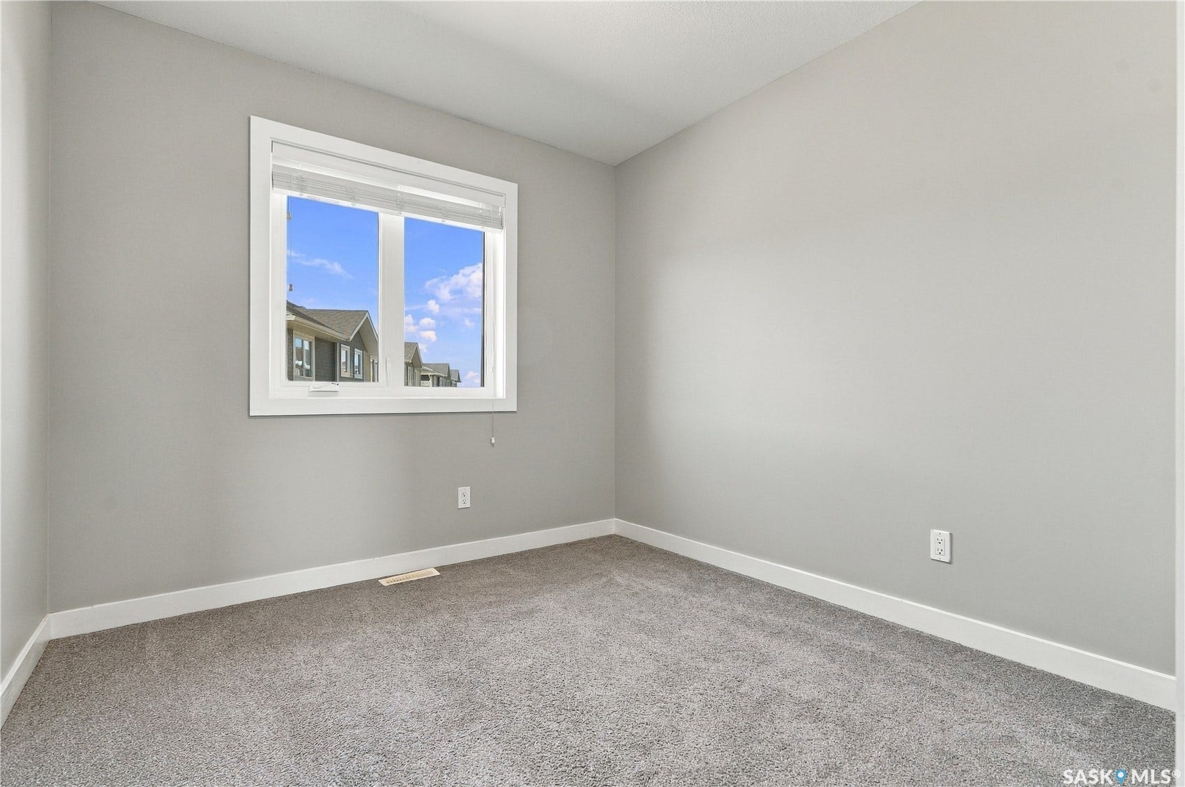 Neutral gray walls complement the gray carpet flooring