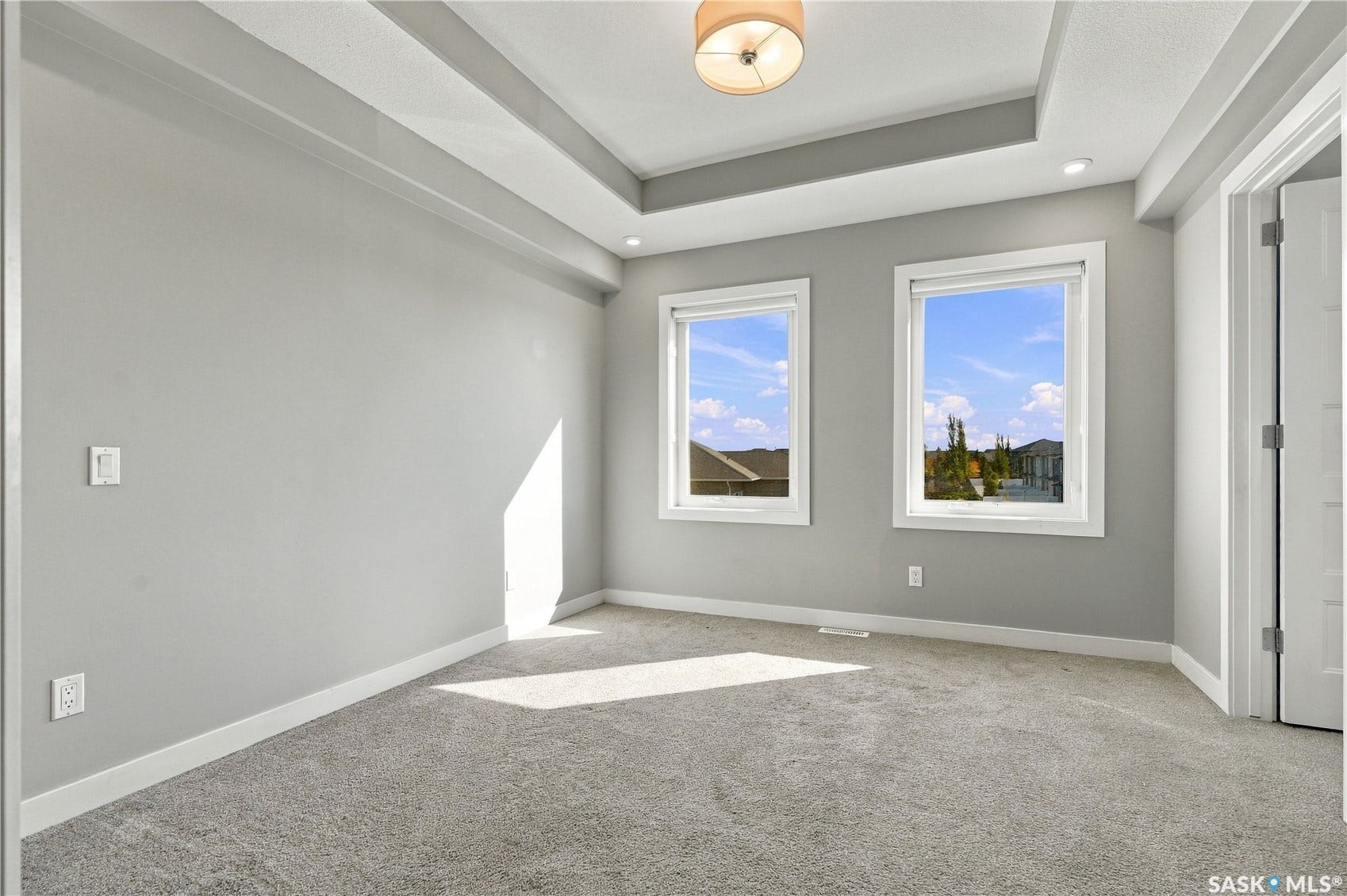 Recessed lighting, tray ceiling, wall-to-wall carpeting, and dual windows