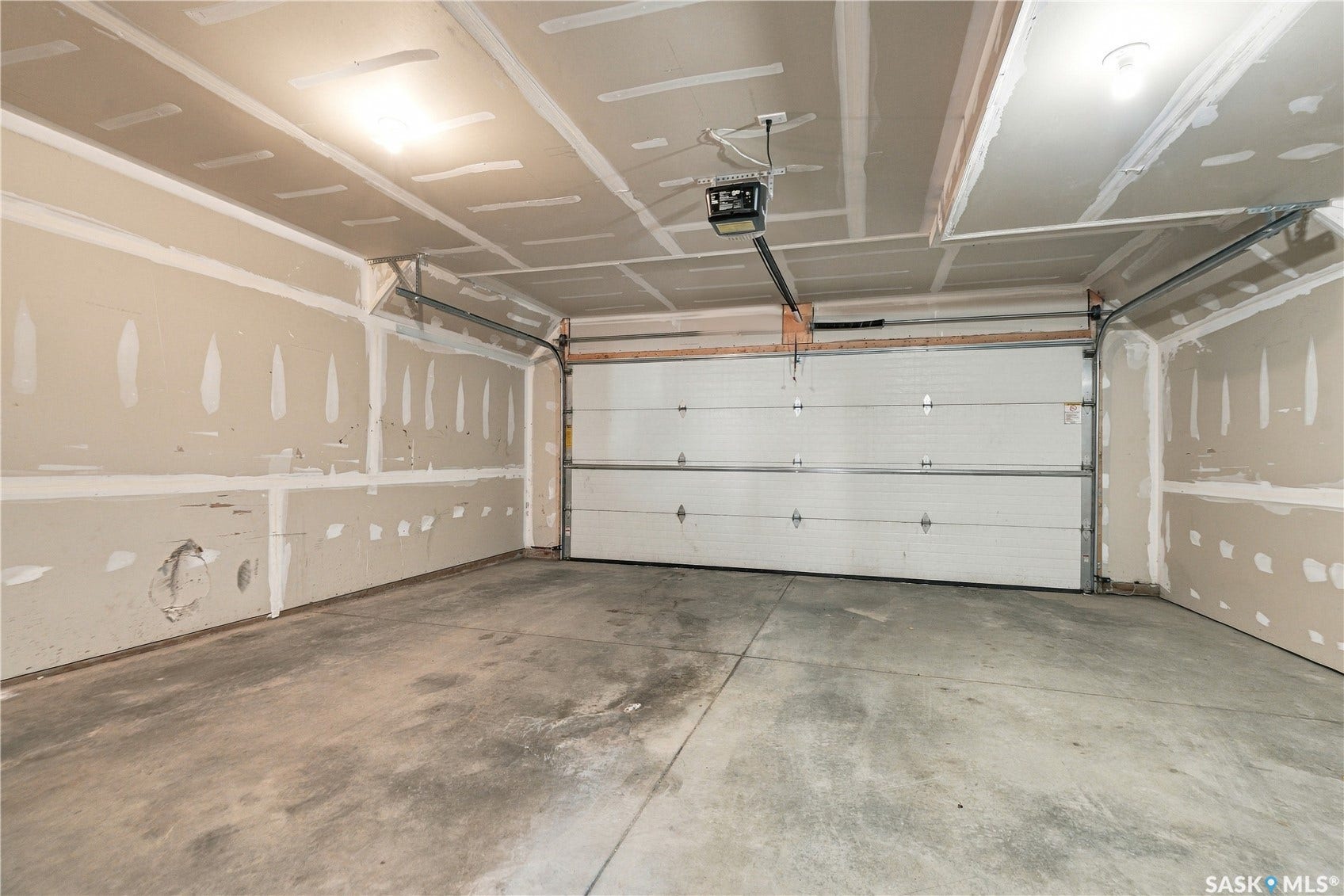 Two-car garage with a concrete floor and a white sectional garage door