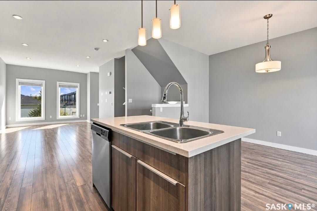 Spacious open-concept layout with wood-finish flooring