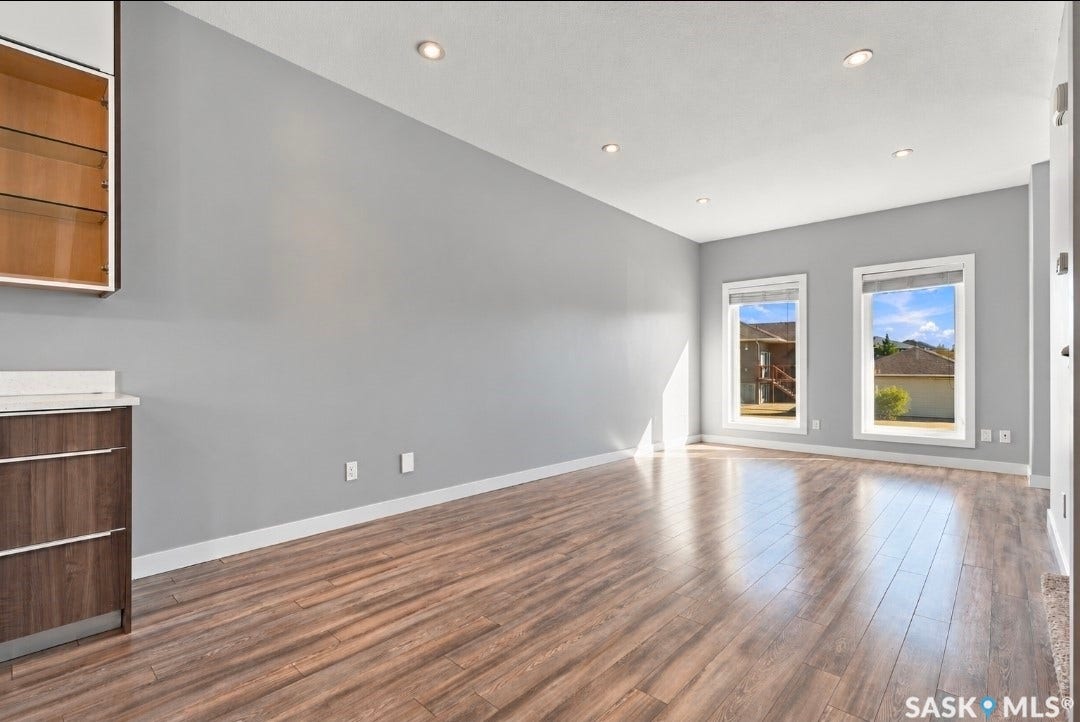 Wood-finish flooring, recessed lighting, and dual windows