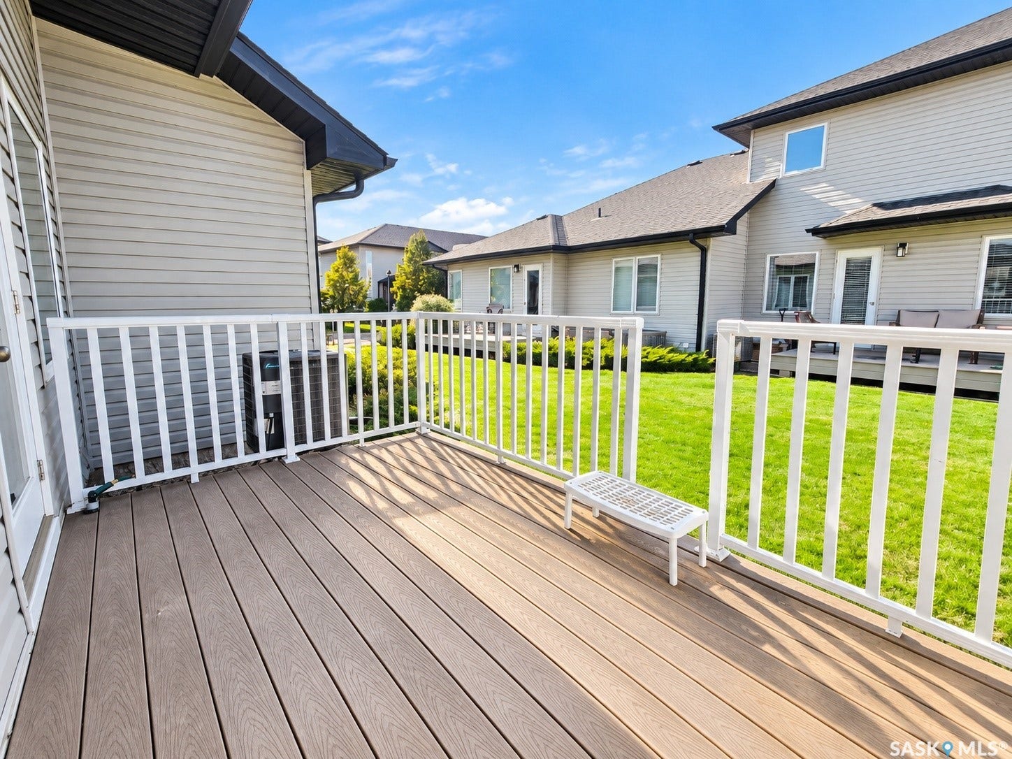 Wood-finish composite decking with white railing