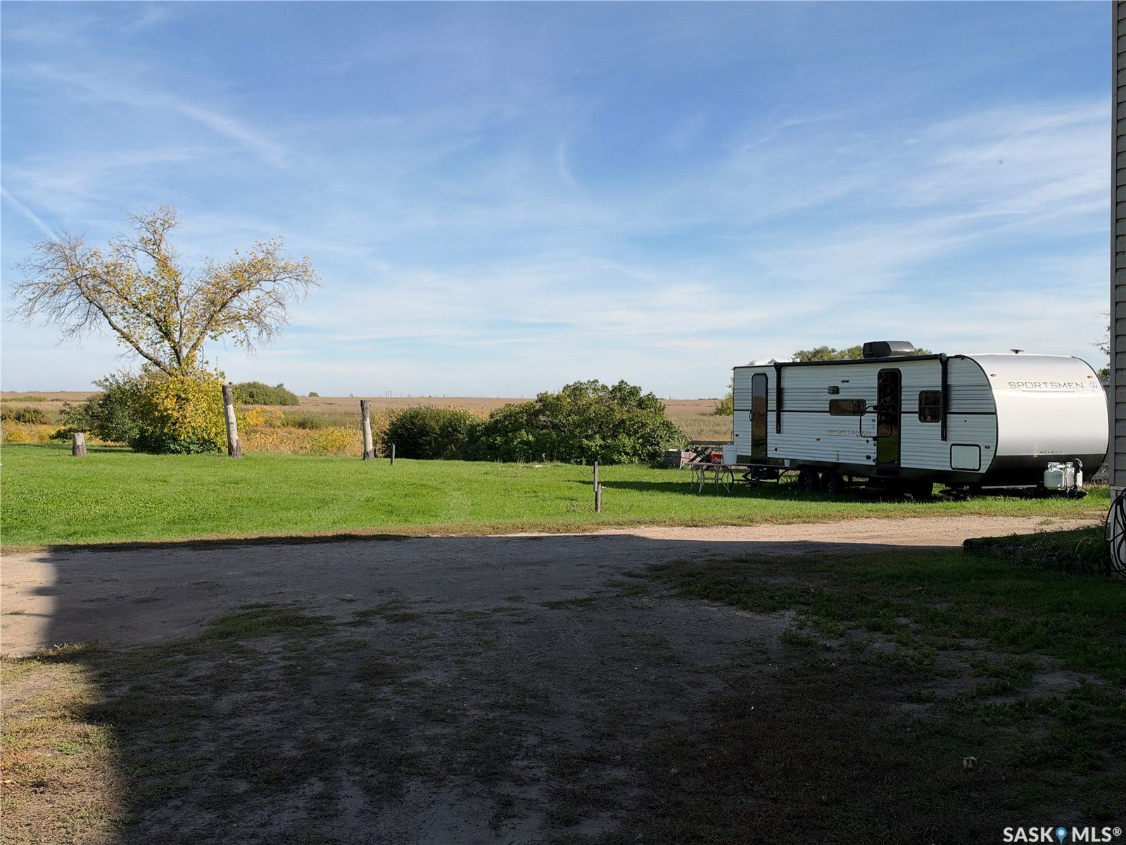 Expansive grass area with a gravel surface
