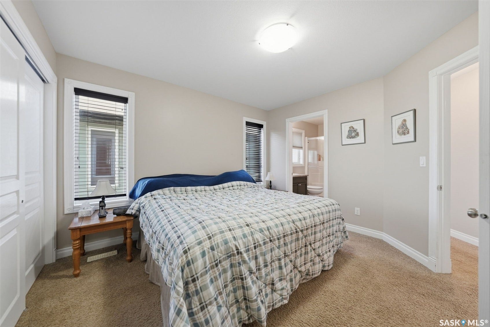 Warm tone wall paint, neutral carpet flooring, recessed window, and white interior doors