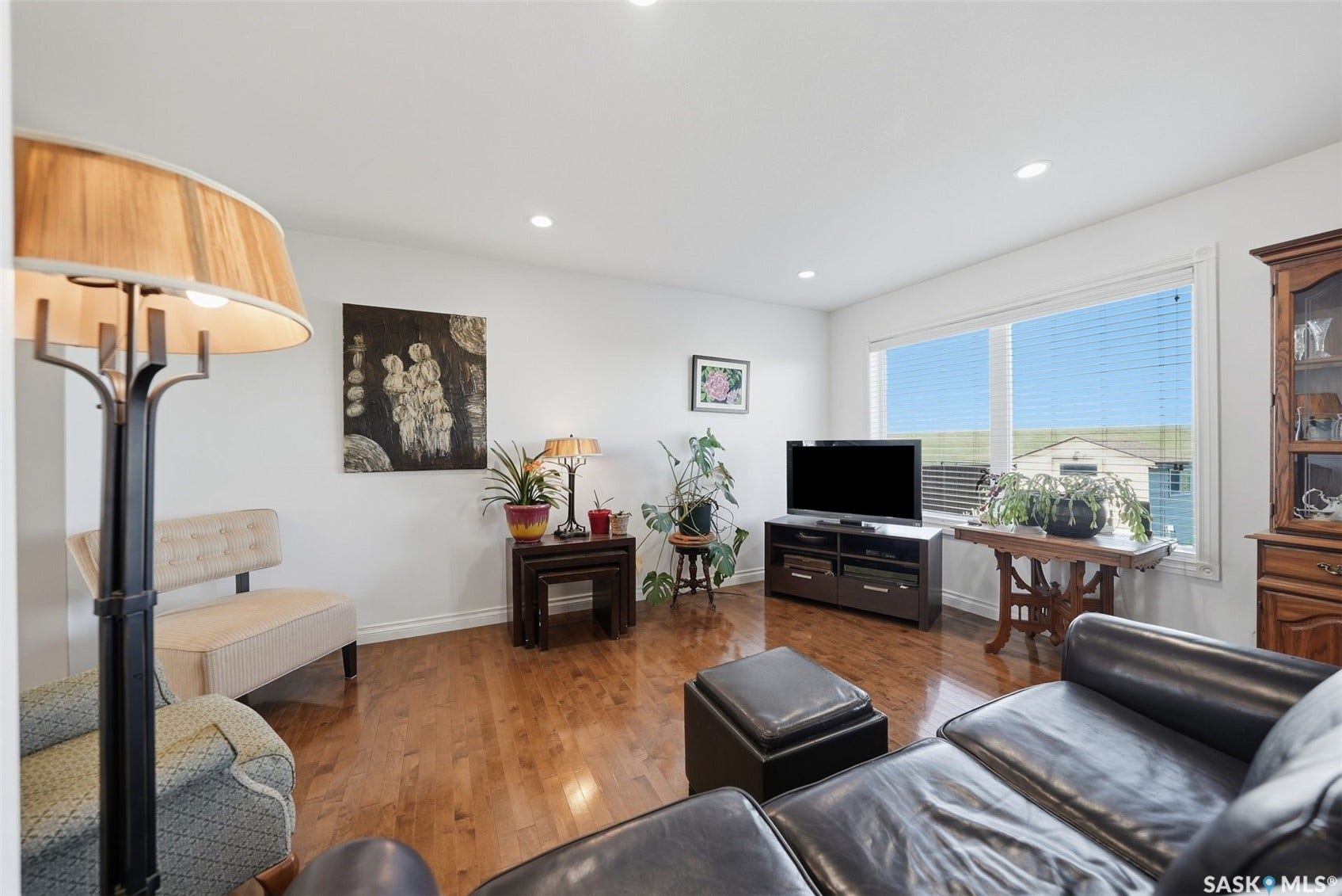Hardwood flooring throughout, recessed ceiling lighting, and expansive windows