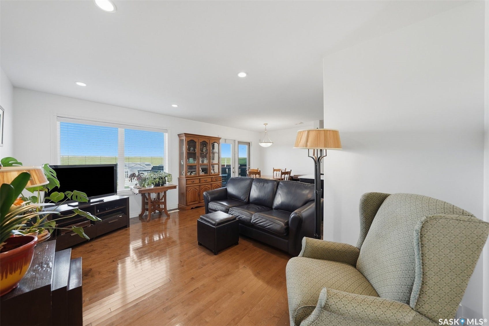 Recessed lighting illuminates the wood-finish flooring