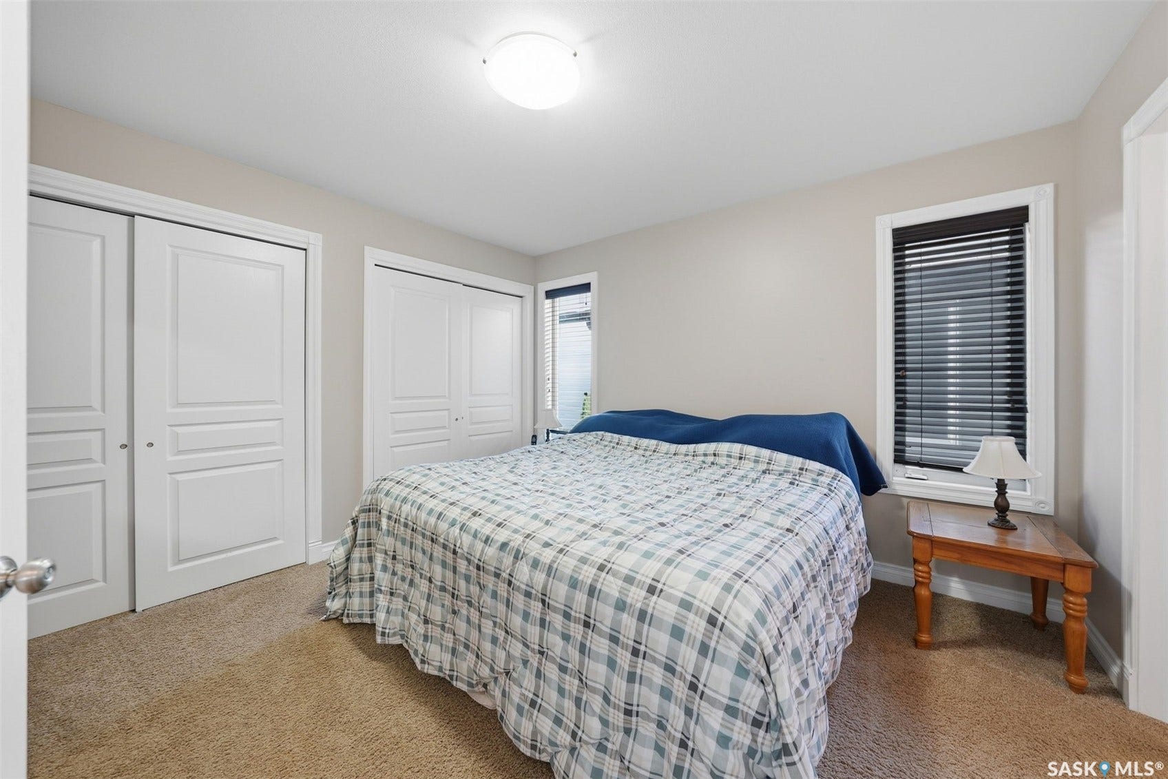 Neutral-toned walls complement the carpeted flooring