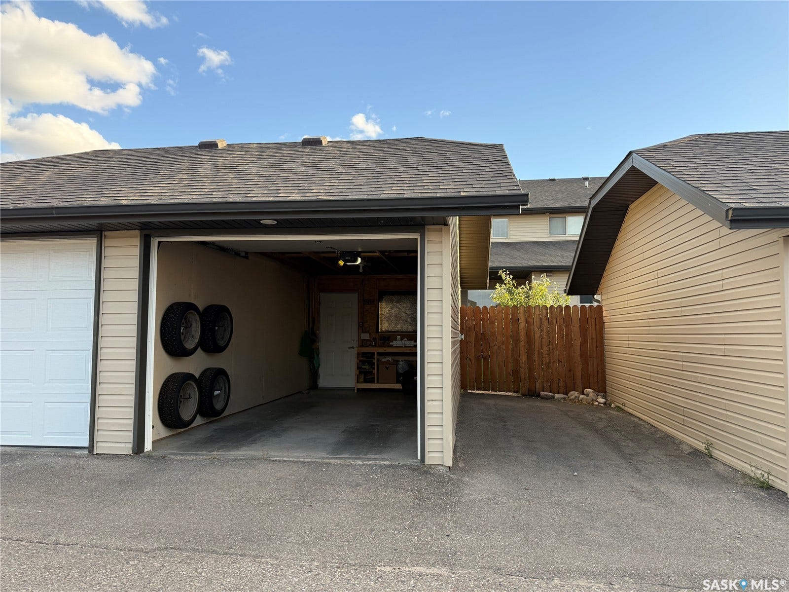 Asphalt shingle roof with dark gutters and beige siding