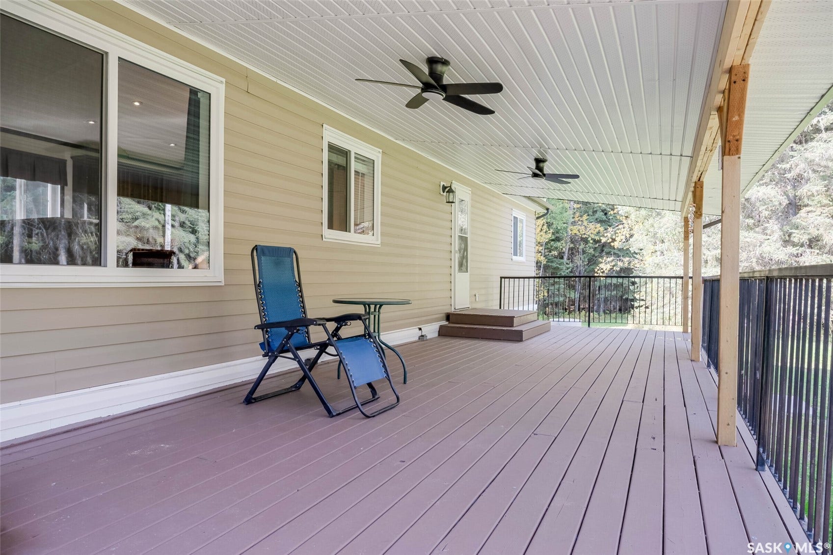 Expansive covered deck with recessed lighting and ceiling fans