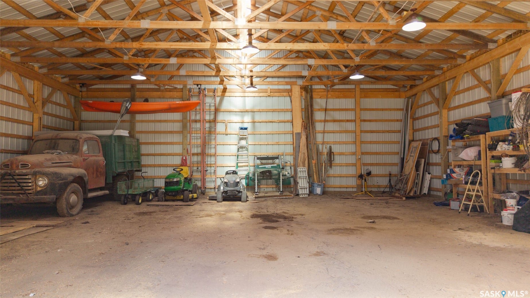 Spacious pole barn with a wood-framed ceiling and corrugated metal siding