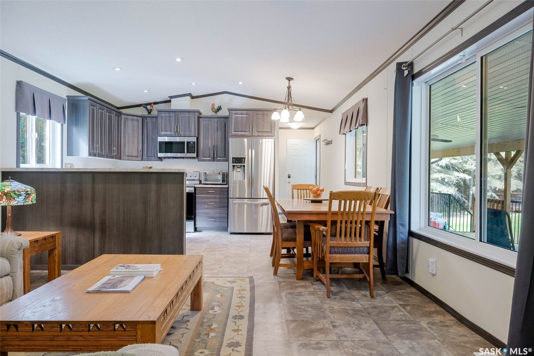 Kitchen featuring stainless steel appliances, dark wood-finish cabinetry, and recessed lighting