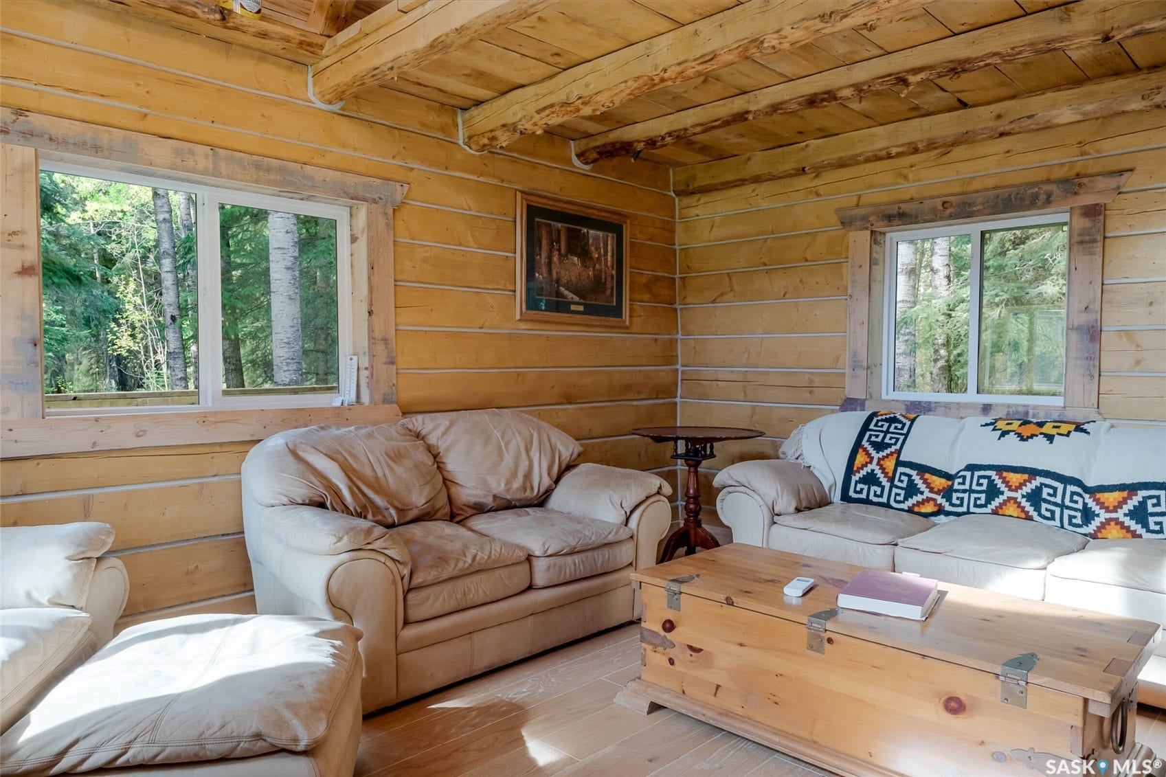 Wood-paneled walls with exposed wood beams and wood-finish flooring