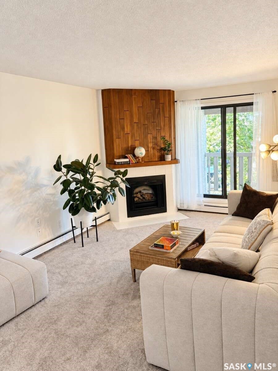 Corner fireplace with a wood-finish accent wall, white hearth, and black firebox