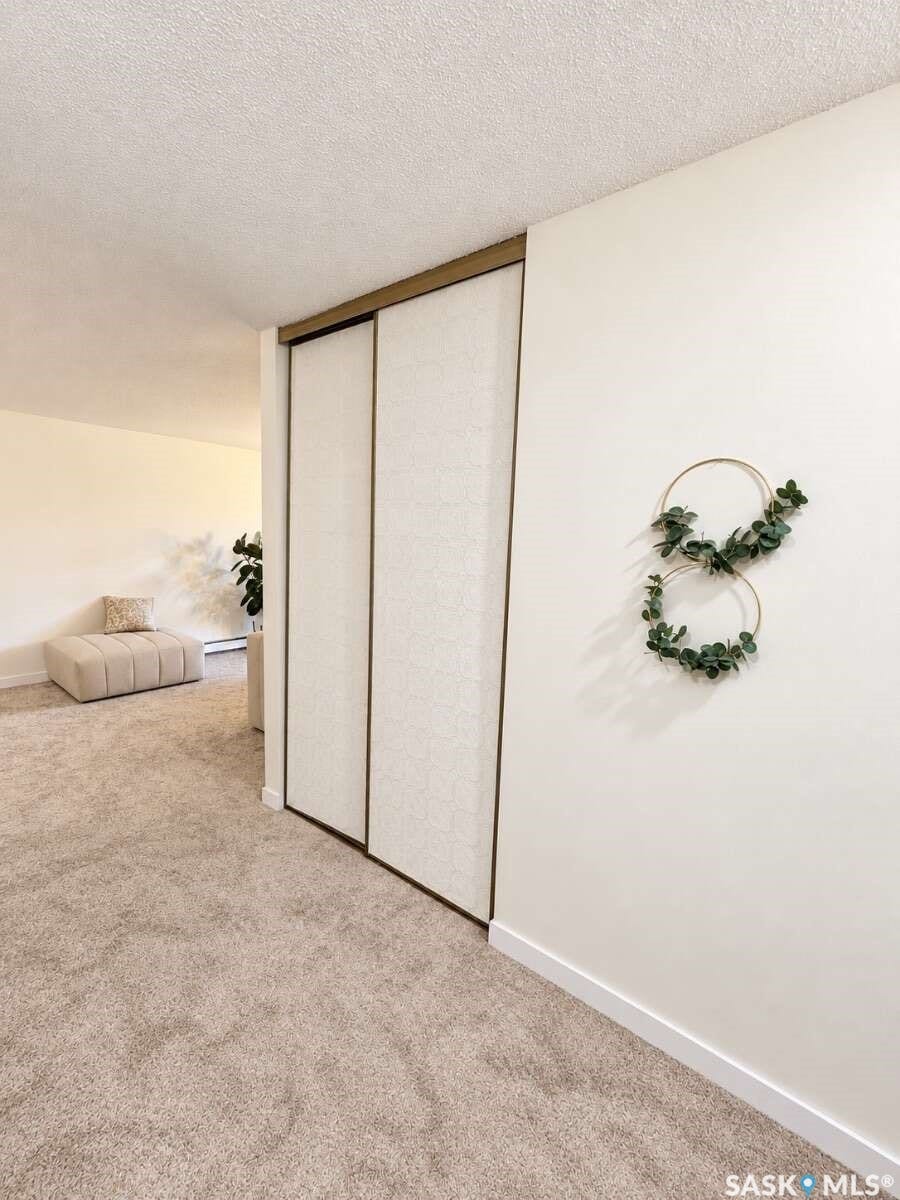 Wall-to-wall carpeting and smooth white walls