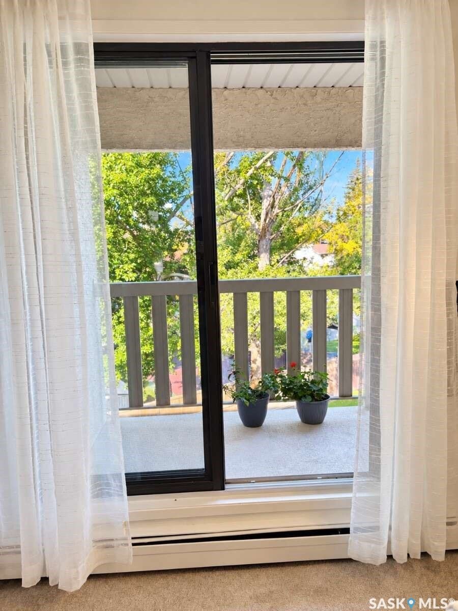 Sliding glass door leading to a private outdoor balcony with a railing