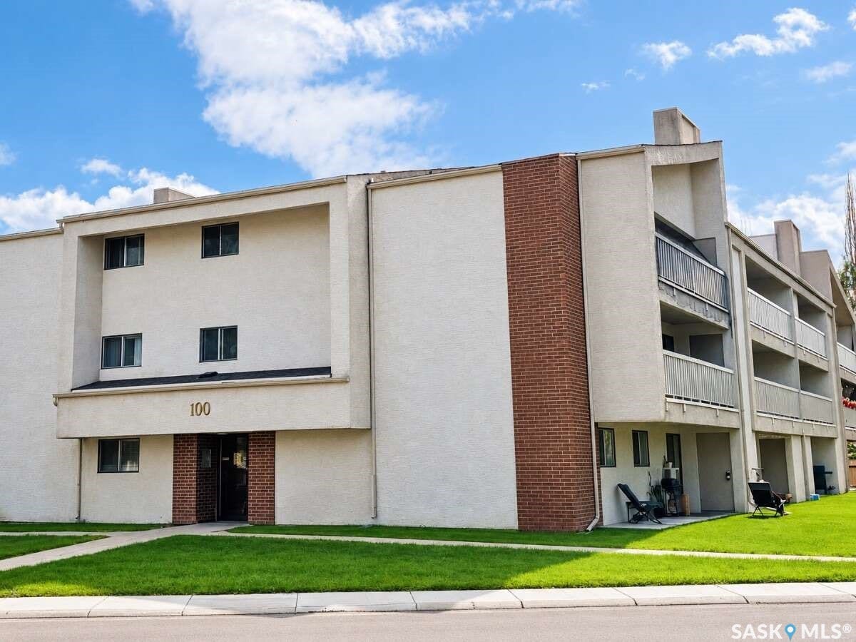 Three-story building with a stucco exterior and brick accents
