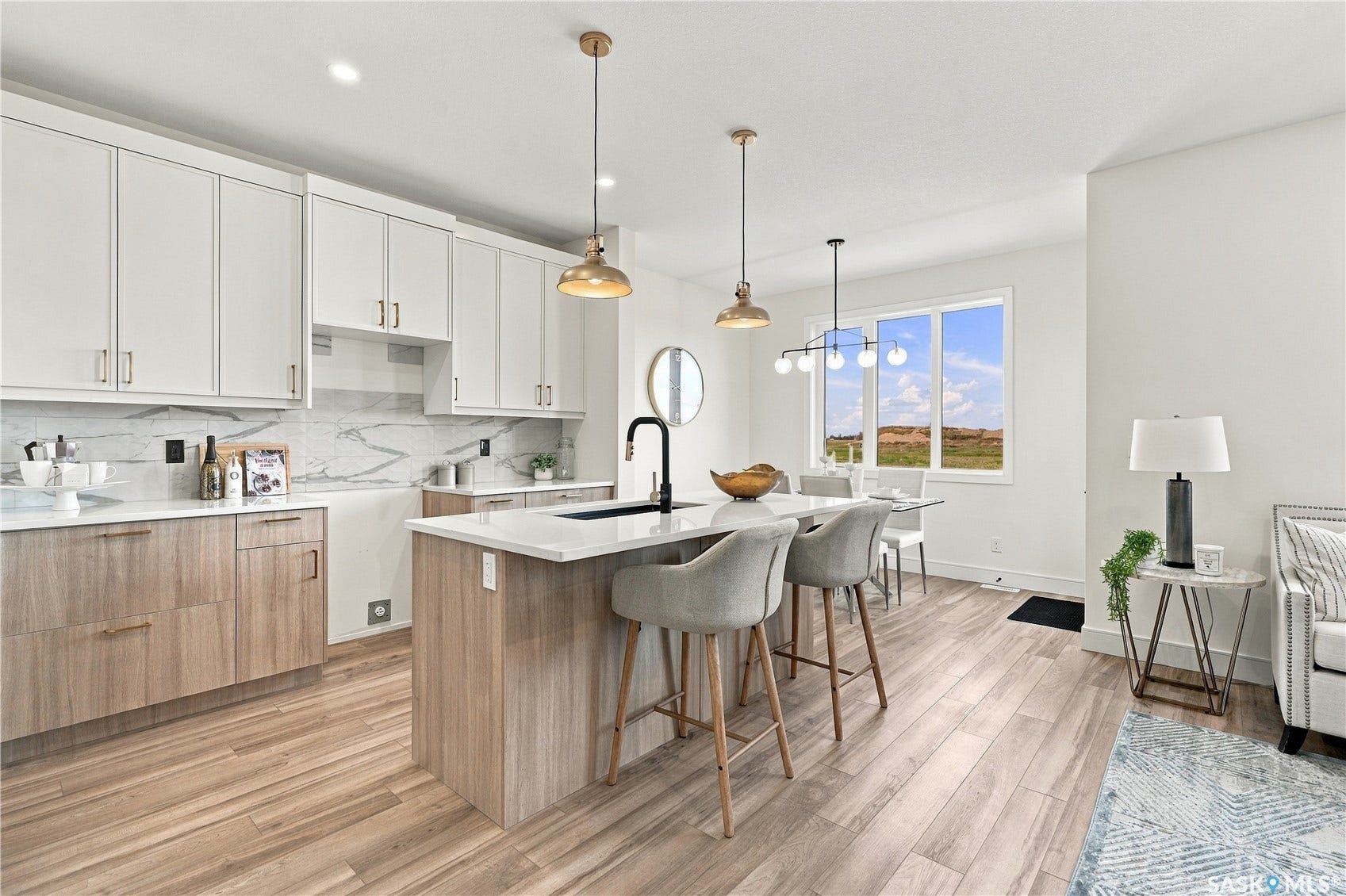 Open-concept kitchen featuring white upper cabinetry, wood-finish lower cabinetry, white countertops, and a full-height backsplash