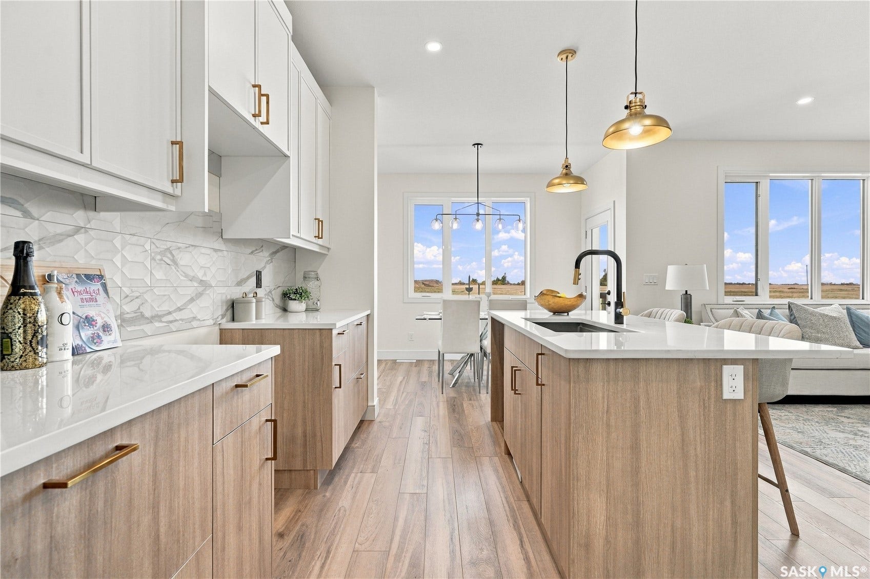 Kitchen featuring white upper cabinetry, wood-finish lower cabinetry, white countertops, and a patterned tile backsplash