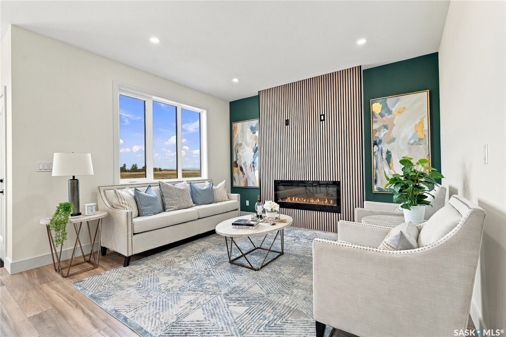 Wood-finish flooring, recessed lighting, and a linear electric fireplace with a wood-slat accent wall