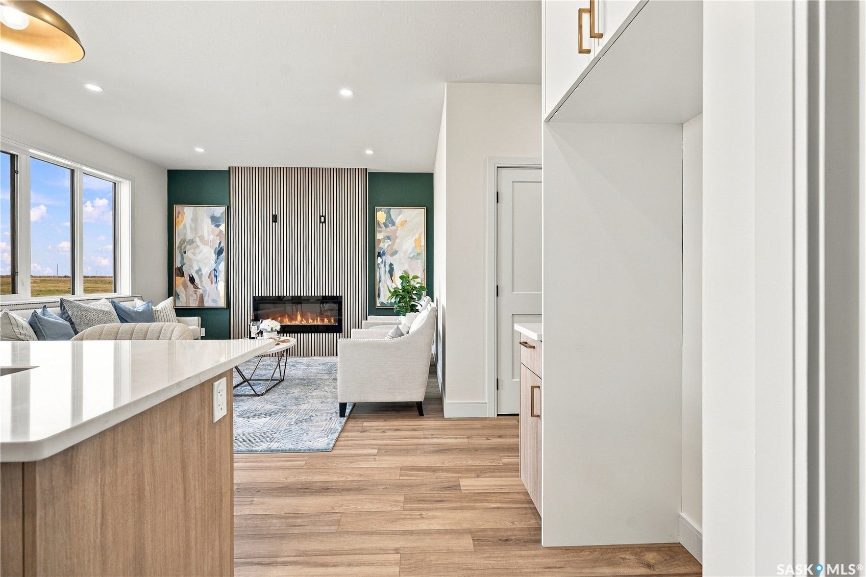 Contemporary living area featuring wood-finish flooring, a linear electric fireplace, recessed lighting, and expansive windows