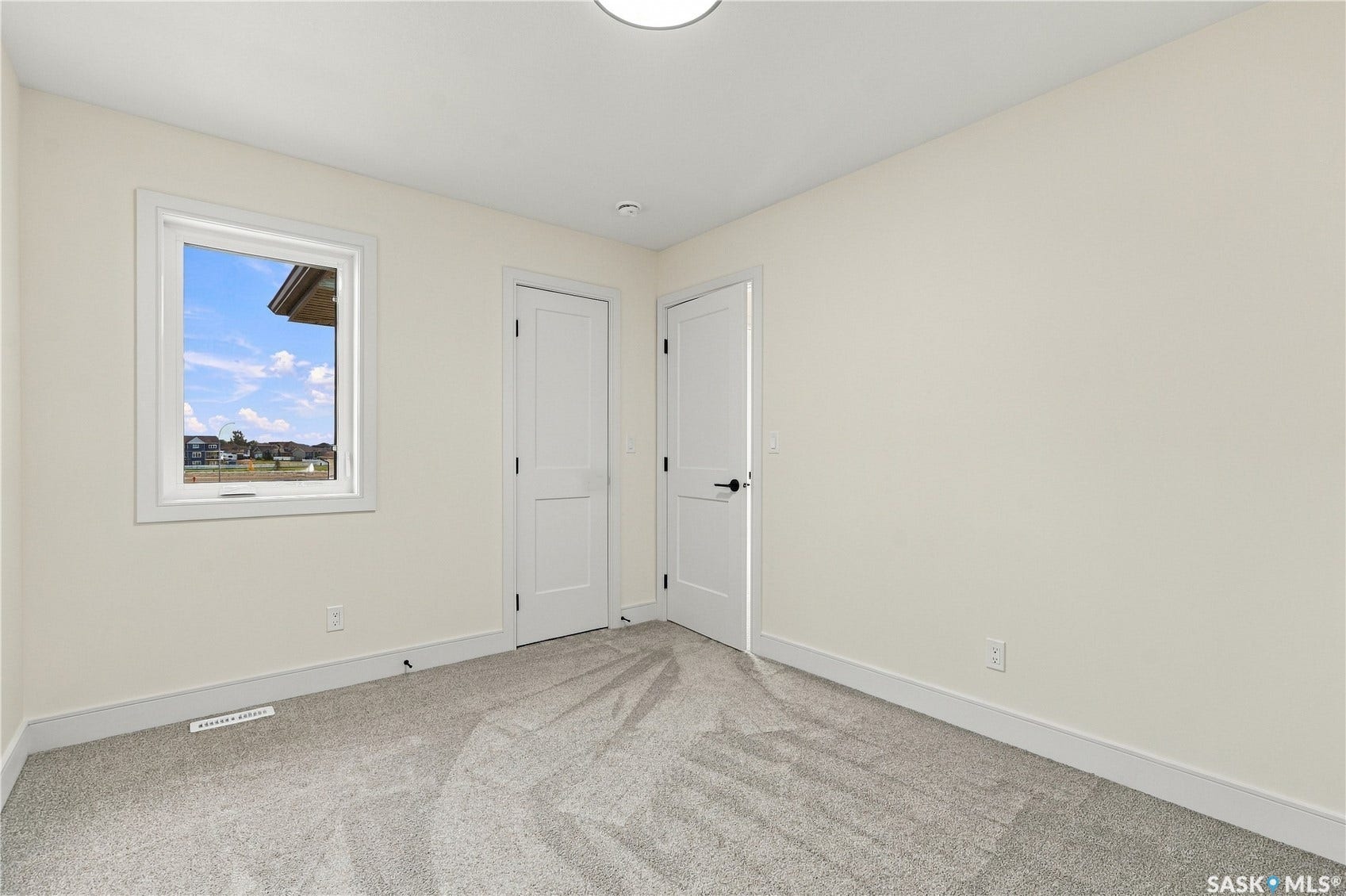 Neutral wall finishes, recessed lighting, and soft carpeting