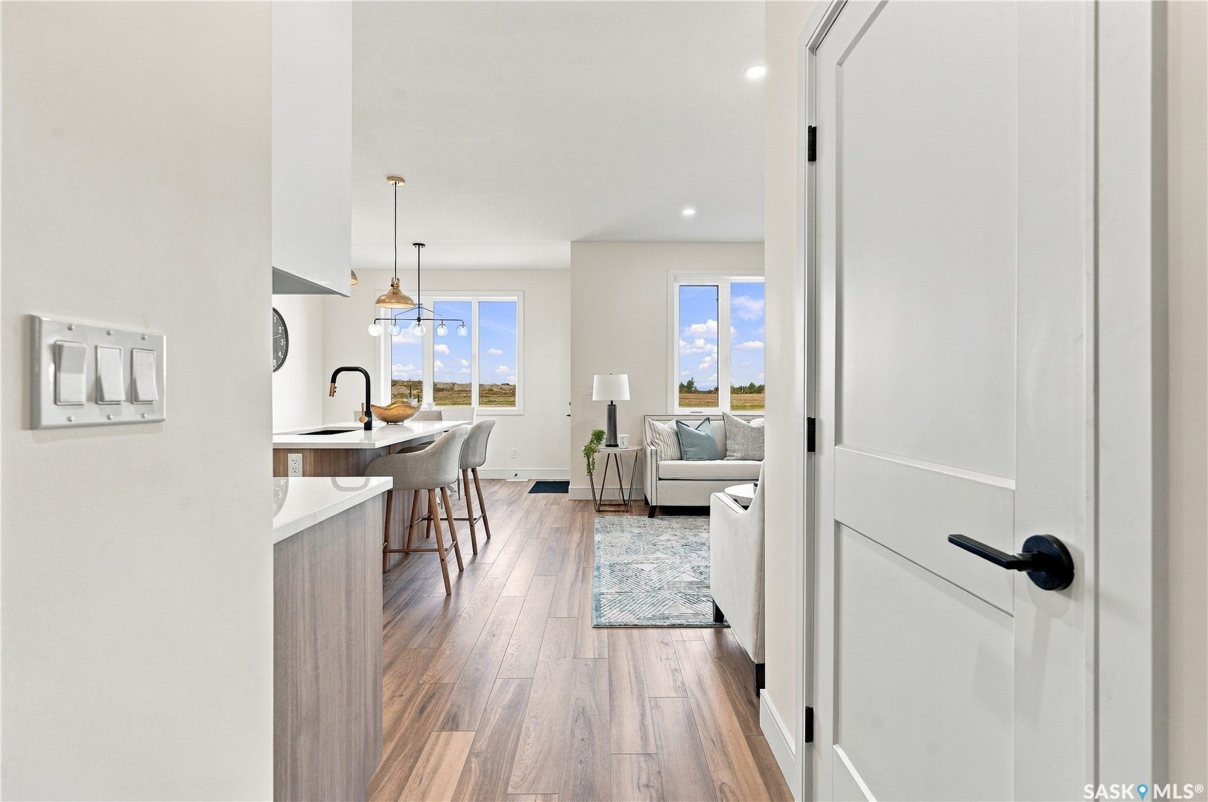 Wood-finish flooring throughout, with a contemporary interior door featuring matte black hardware