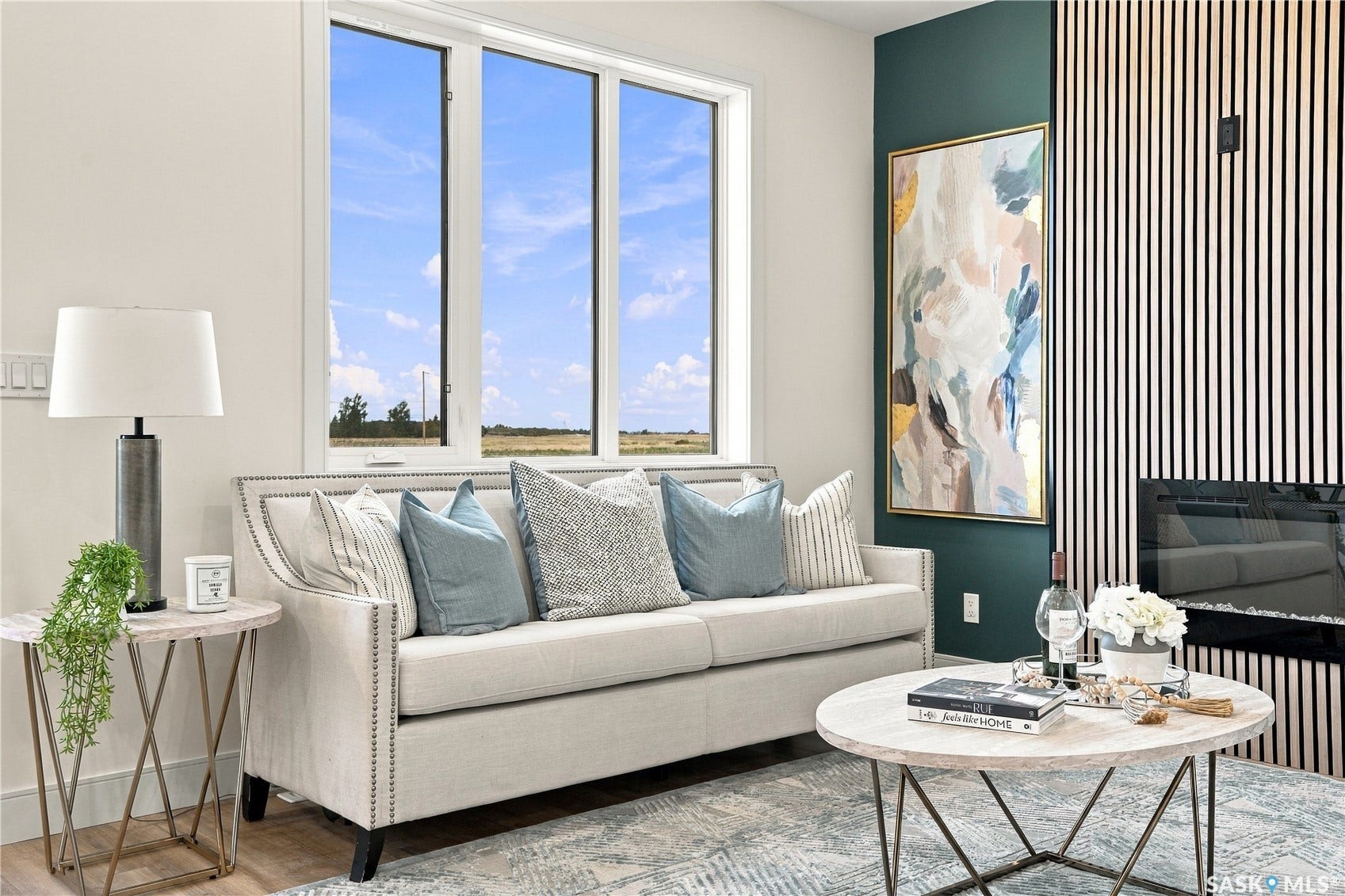 Large windows with white trim, a built-in fireplace, and a textured wall panel accent