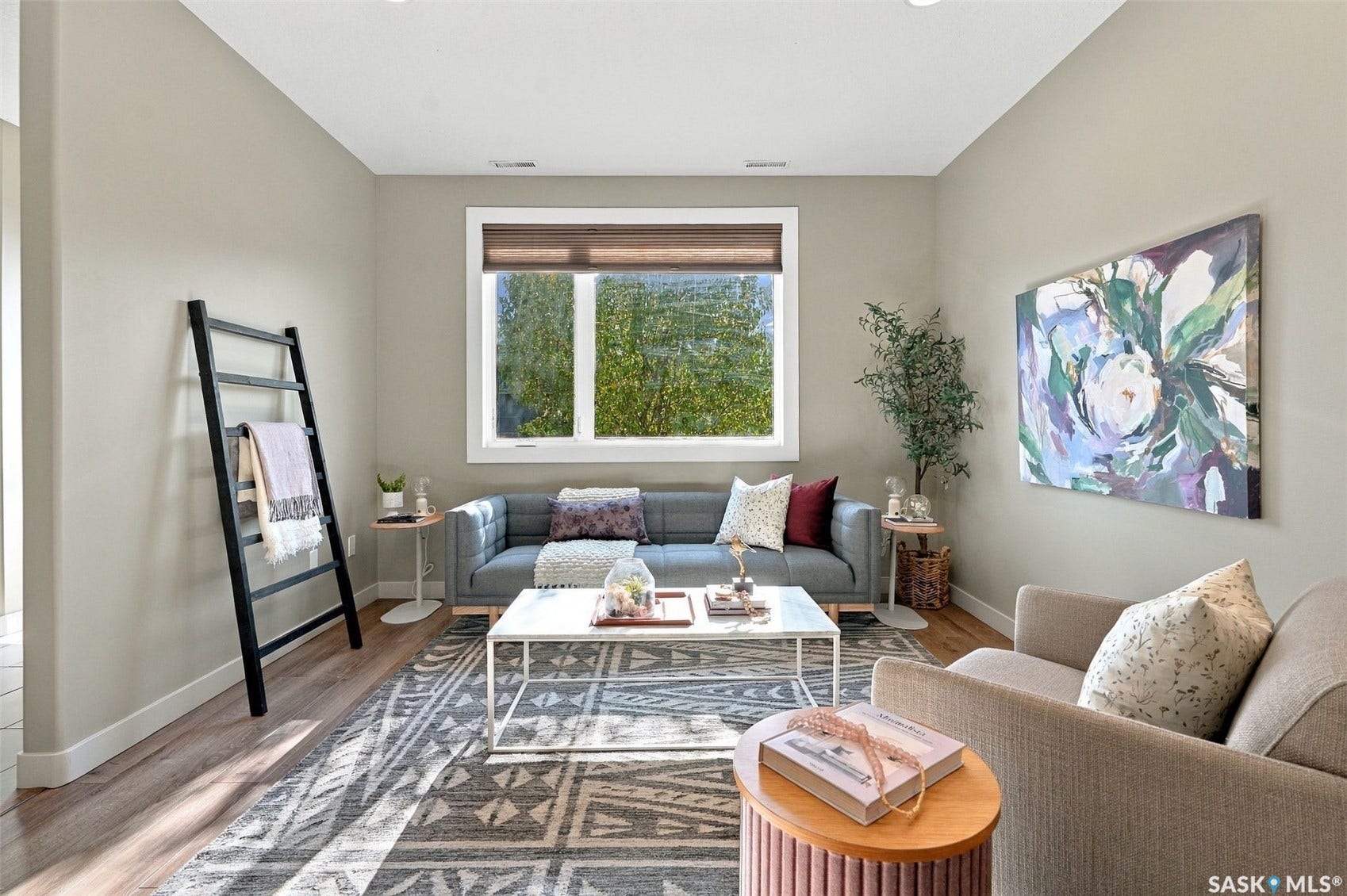 Recessed ceiling lighting, wood-finish flooring, neutral wall tones, and a large window with privacy blinds