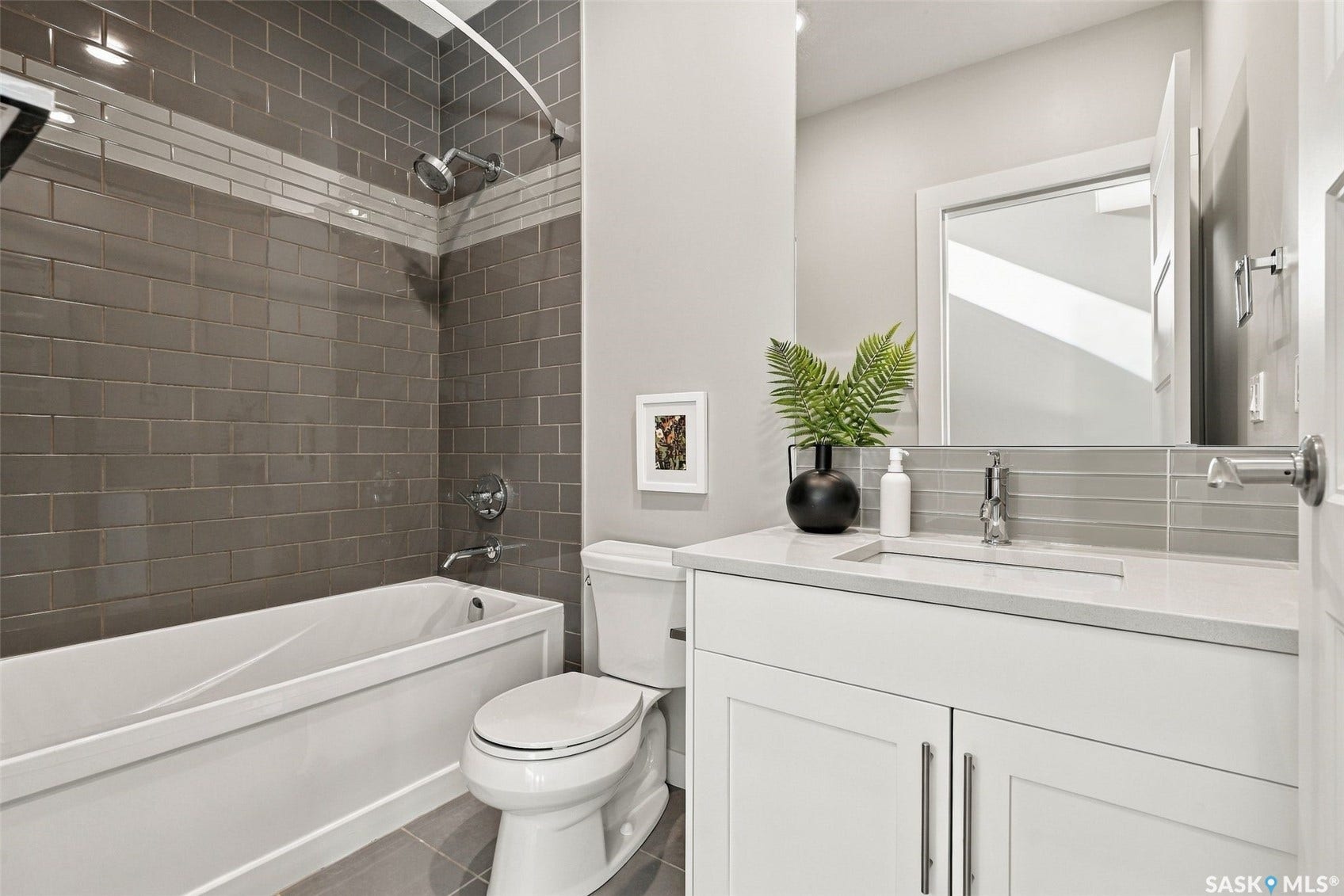 White vanity with chrome hardware, integrated rectangular sink, and single-handle faucet